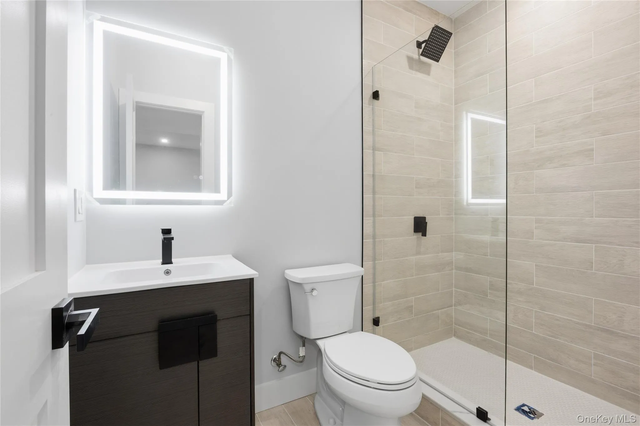 Bathroom featuring vanity and tiled shower Bathroom featuring vanity and tiled shower