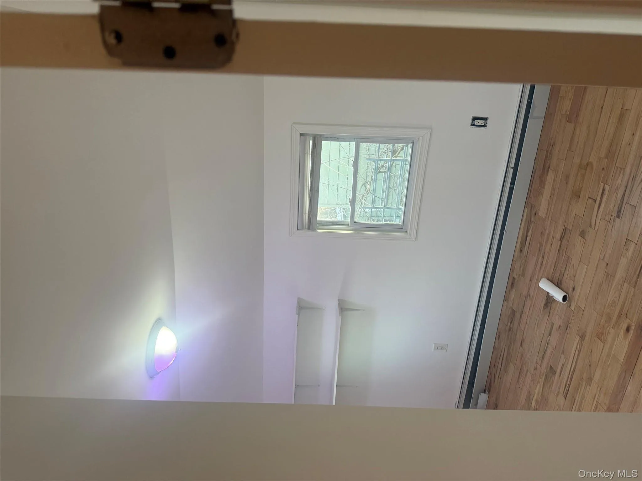 Spare room with a baseboard heating unit, light wood finished floors, and vaulted ceiling Spare room with a baseboard heating unit, light wood finished floors, and vaulted ceiling