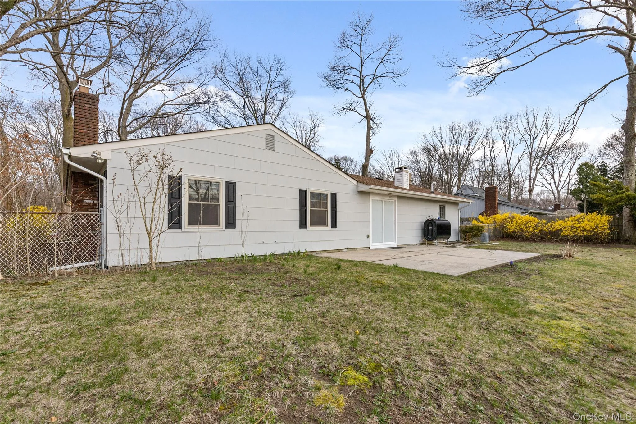 Rear view of property with a chimney, a patio area, and heating fuel Rear view of property with a chimney, a patio area, and heating fuel