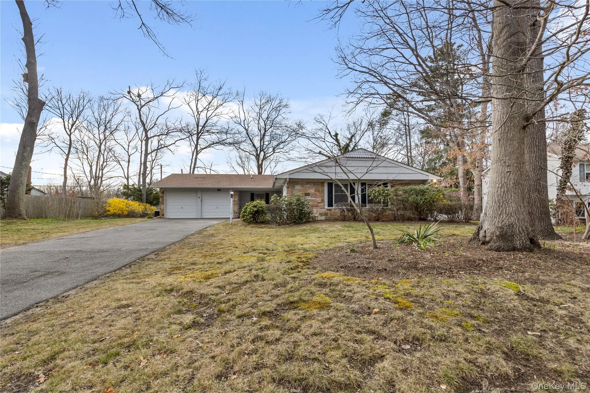 Ranch-style home with driveway, an attached garage, and a front lawn Ranch-style home with driveway, an attached garage, and a front lawn