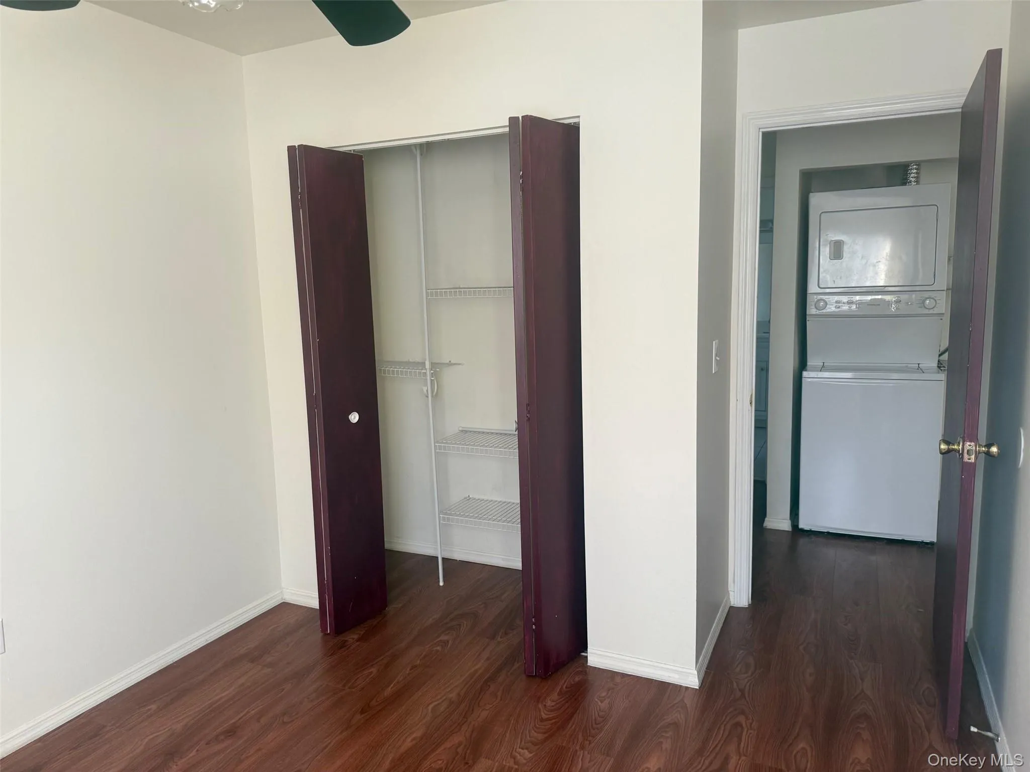Another angle of bedroom with a closet and showing the washer and dryer in hallway Another angle of bedroom with a closet and showing the washer and dryer in hallway