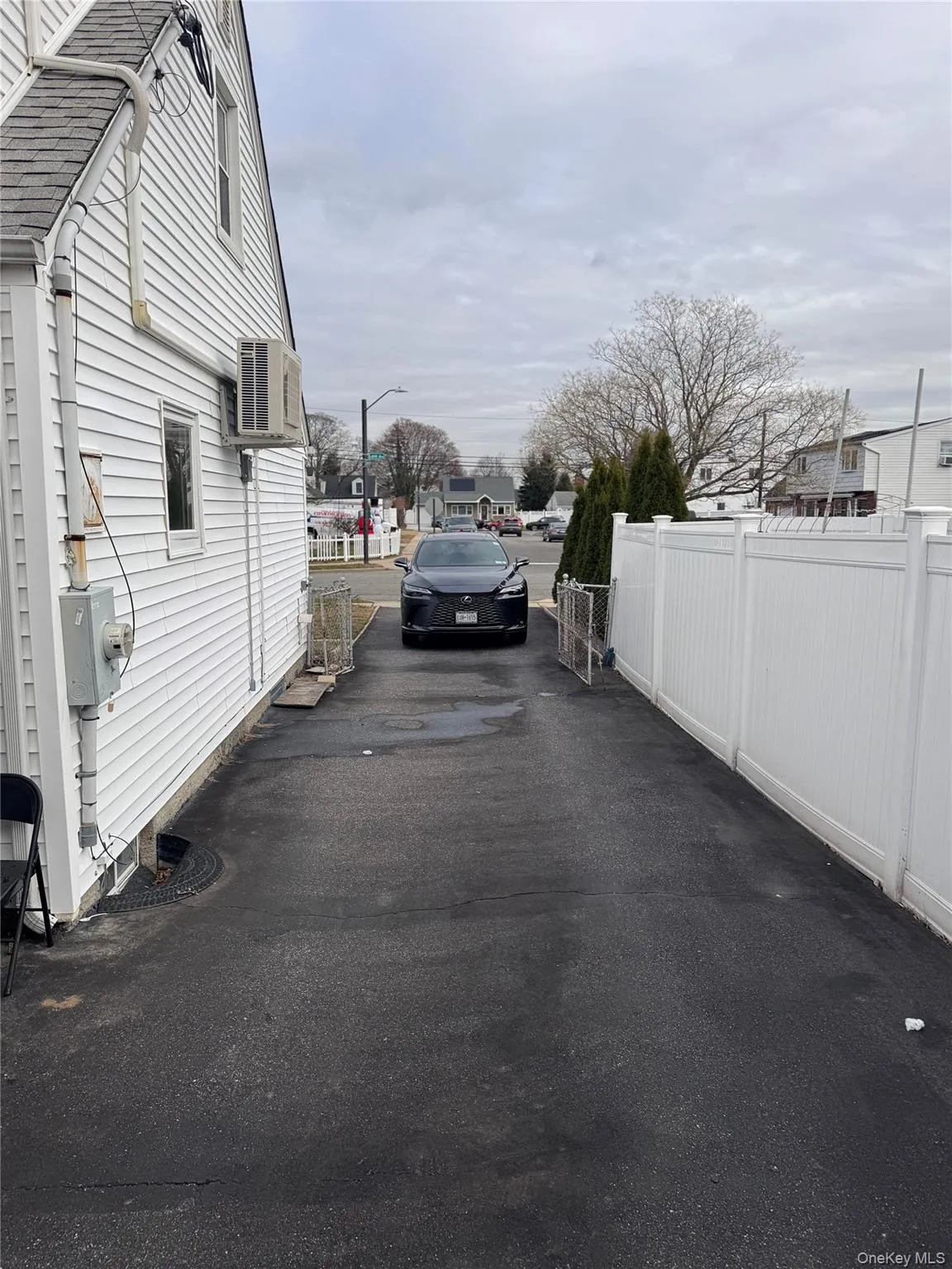 View of asphalt road featuring street lighting View of asphalt road featuring street lighting