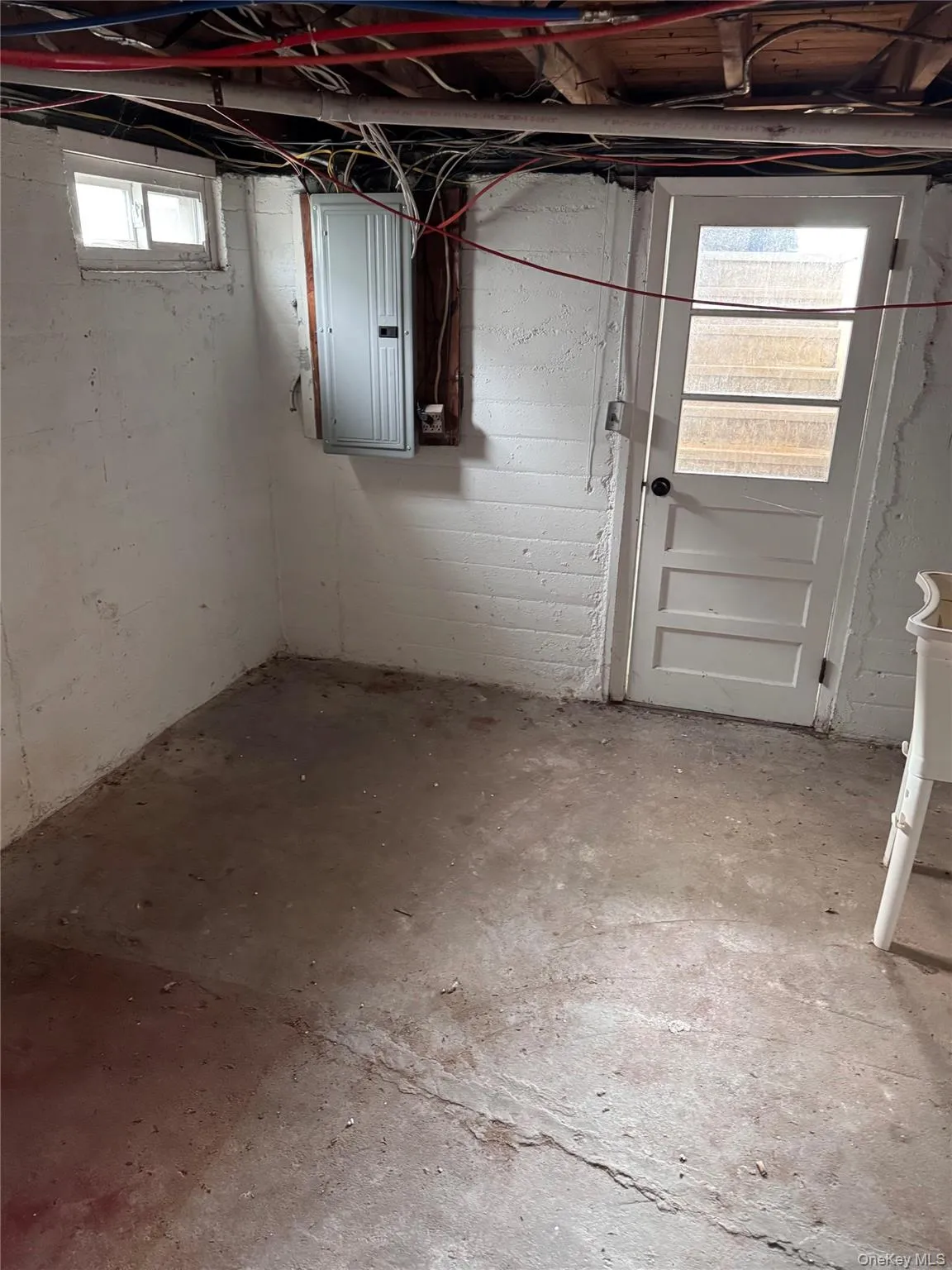 Basement featuring electric panel Basement featuring electric panel
