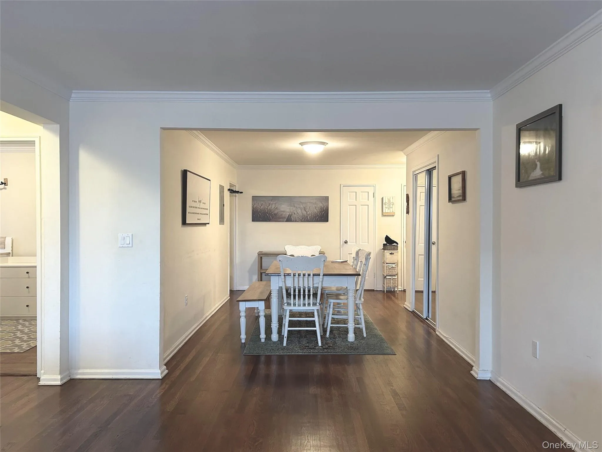 Dining space featuring ornamental molding and dark wood-type flooring Dining space featuring ornamental molding and dark wood-type flooring