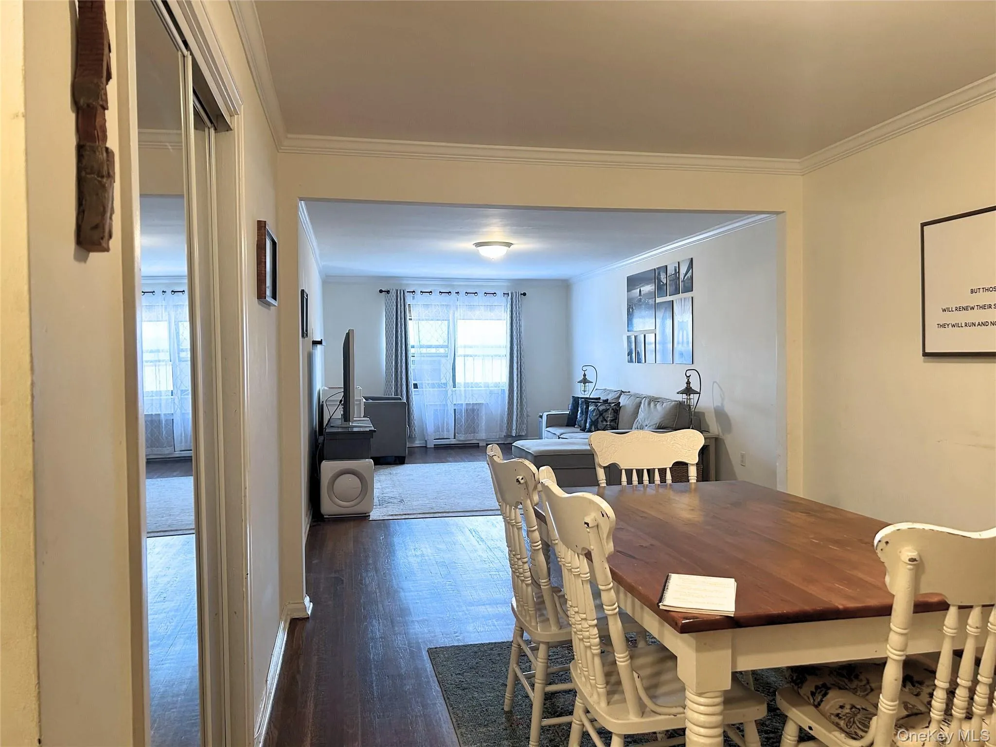 Dining room with crown molding and dark wood finished floors Dining room with crown molding and dark wood finished floors
