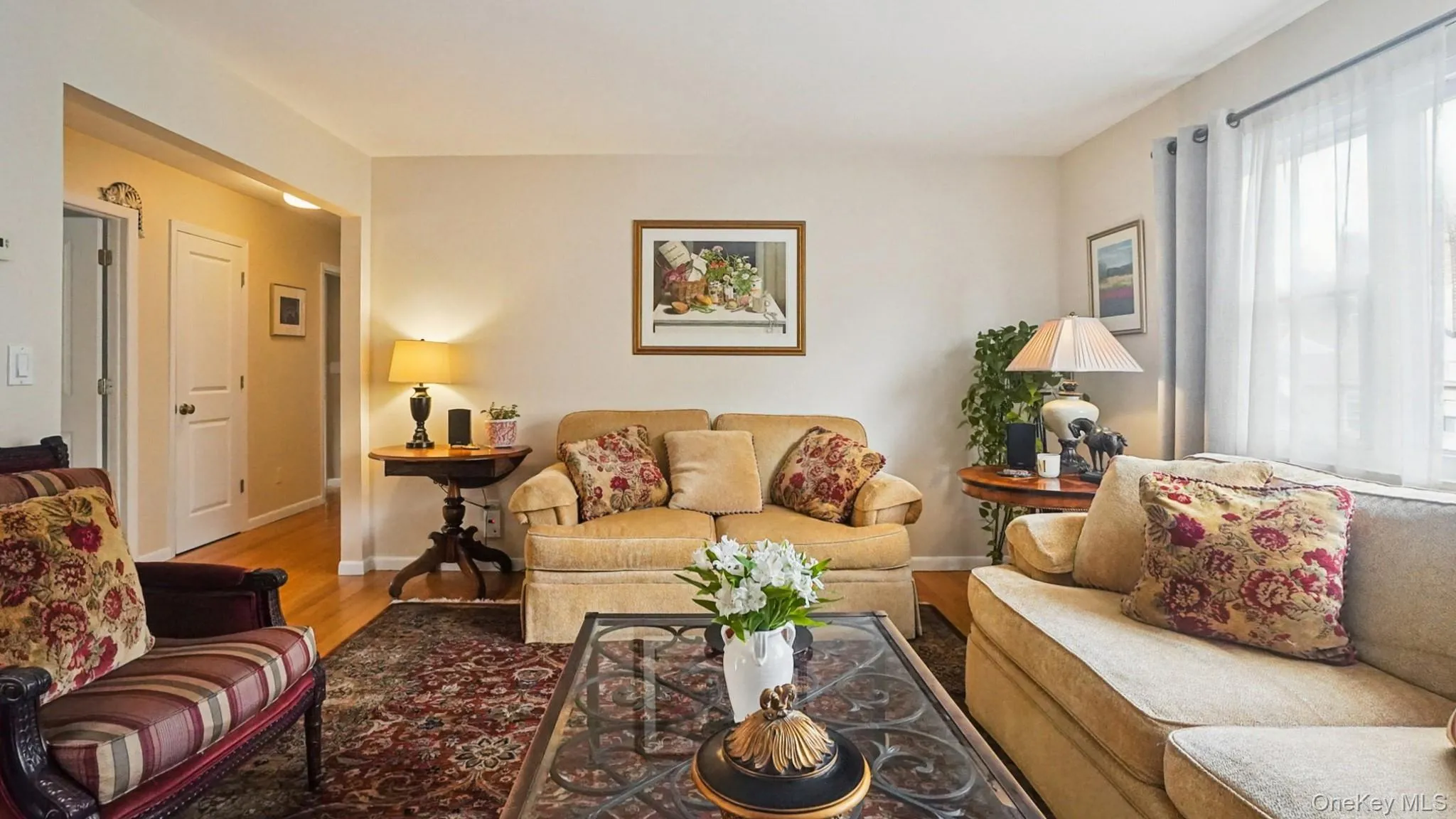 Living area with wood finished floors and baseboards Living area with wood finished floors and baseboards