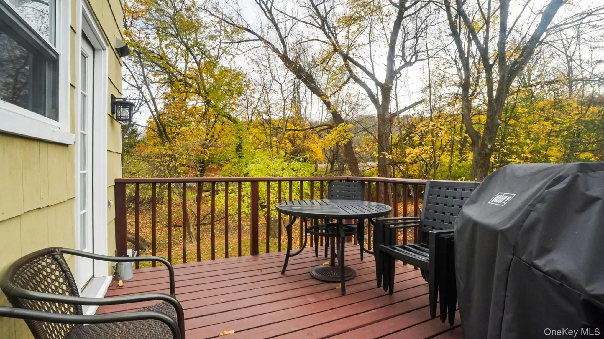 Wooden deck with area for grilling and outdoor dining area Wooden deck with area for grilling and outdoor dining area