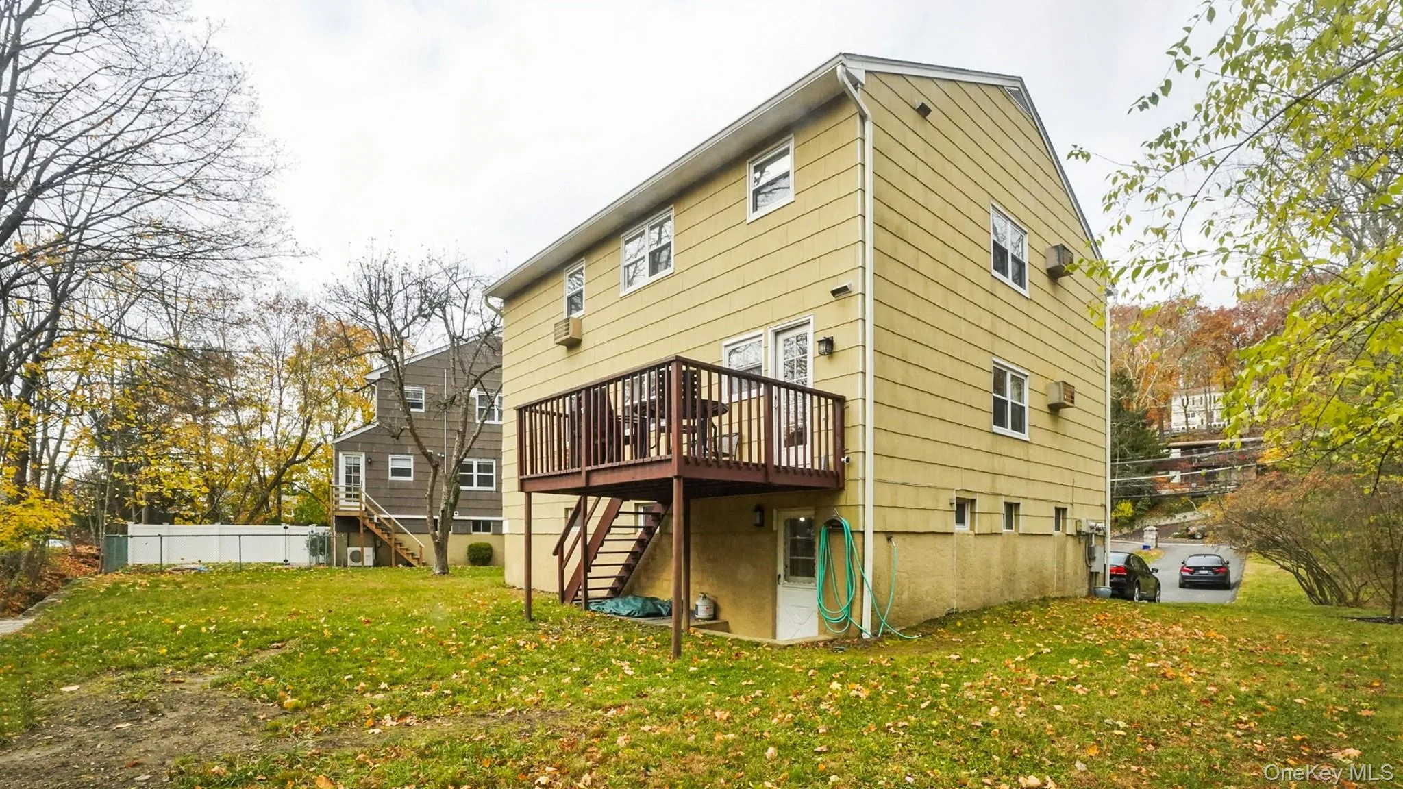 Back of house with stairs and a deck Back of house with stairs and a deck