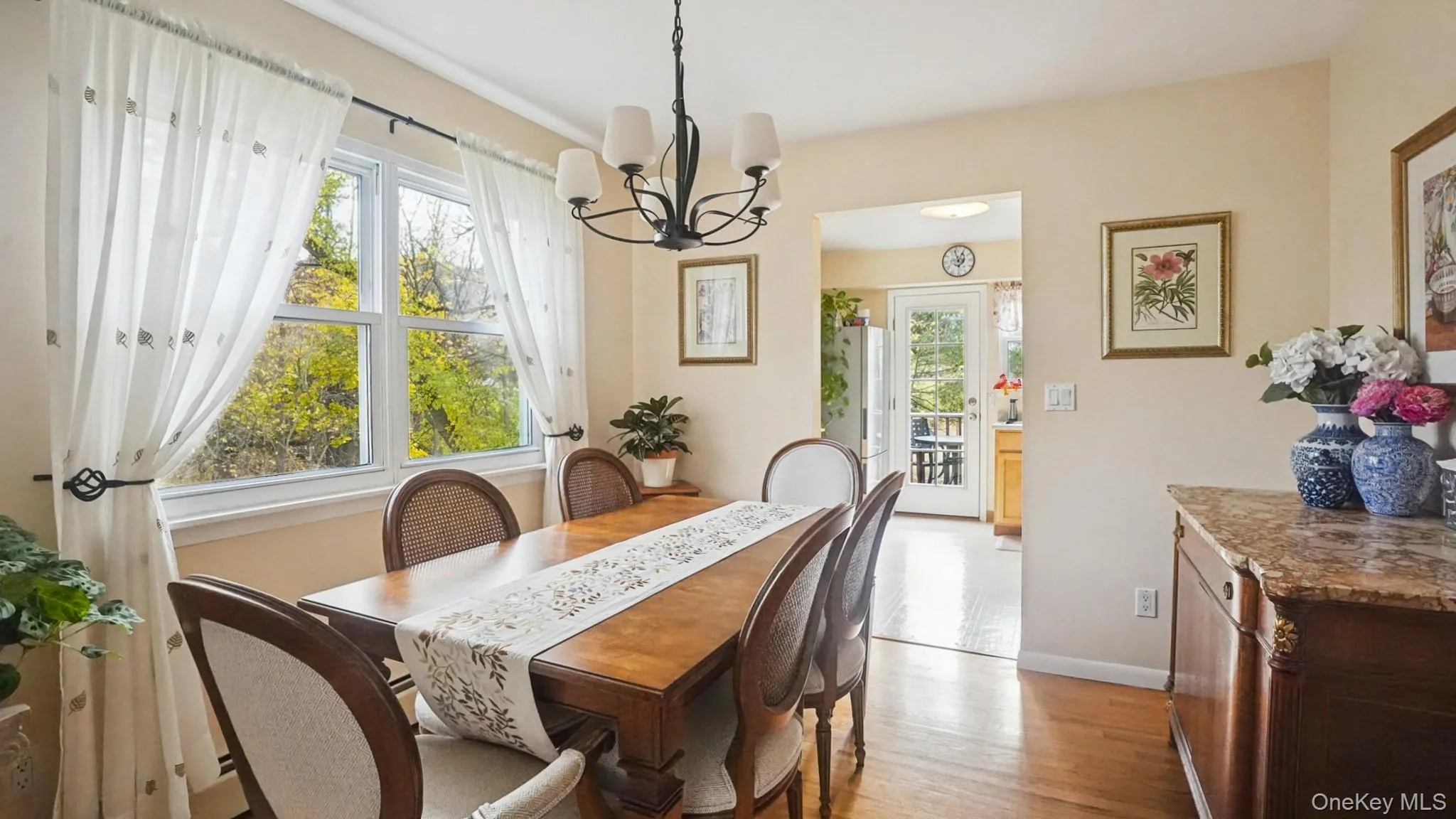 Dining room with a chandelier and light wood-type flooring Dining room with a chandelier and light wood-type flooring
