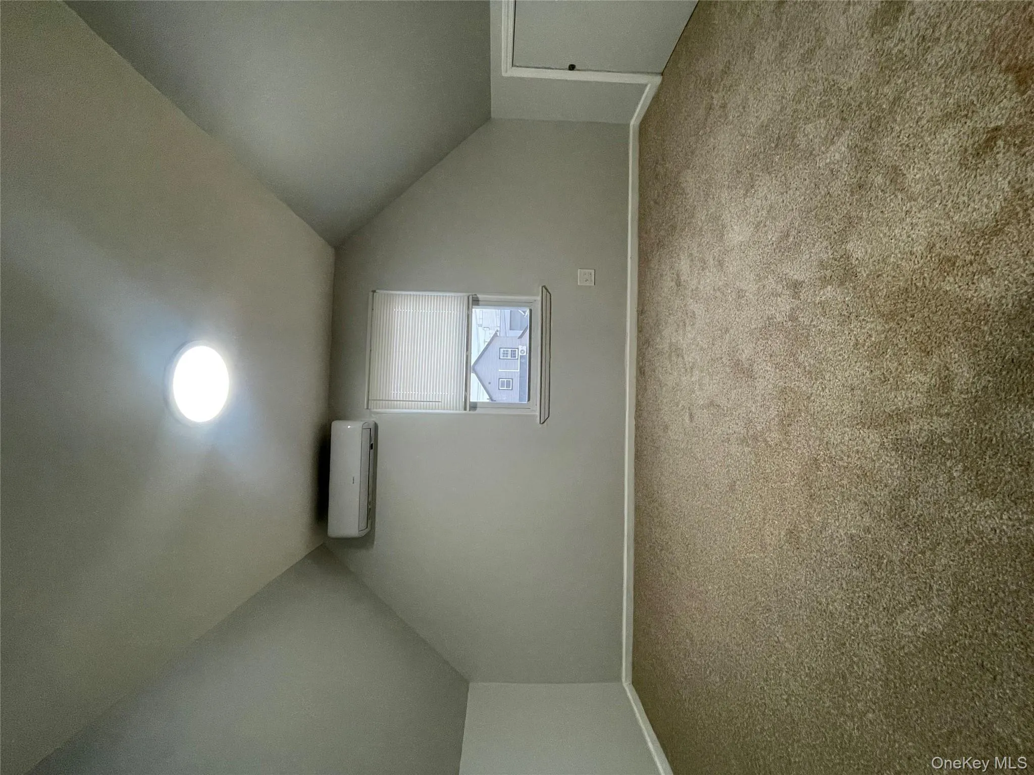 Bonus room featuring vaulted ceiling, carpet floors, and an AC wall unit Bonus room featuring vaulted ceiling, carpet floors, and an AC wall unit