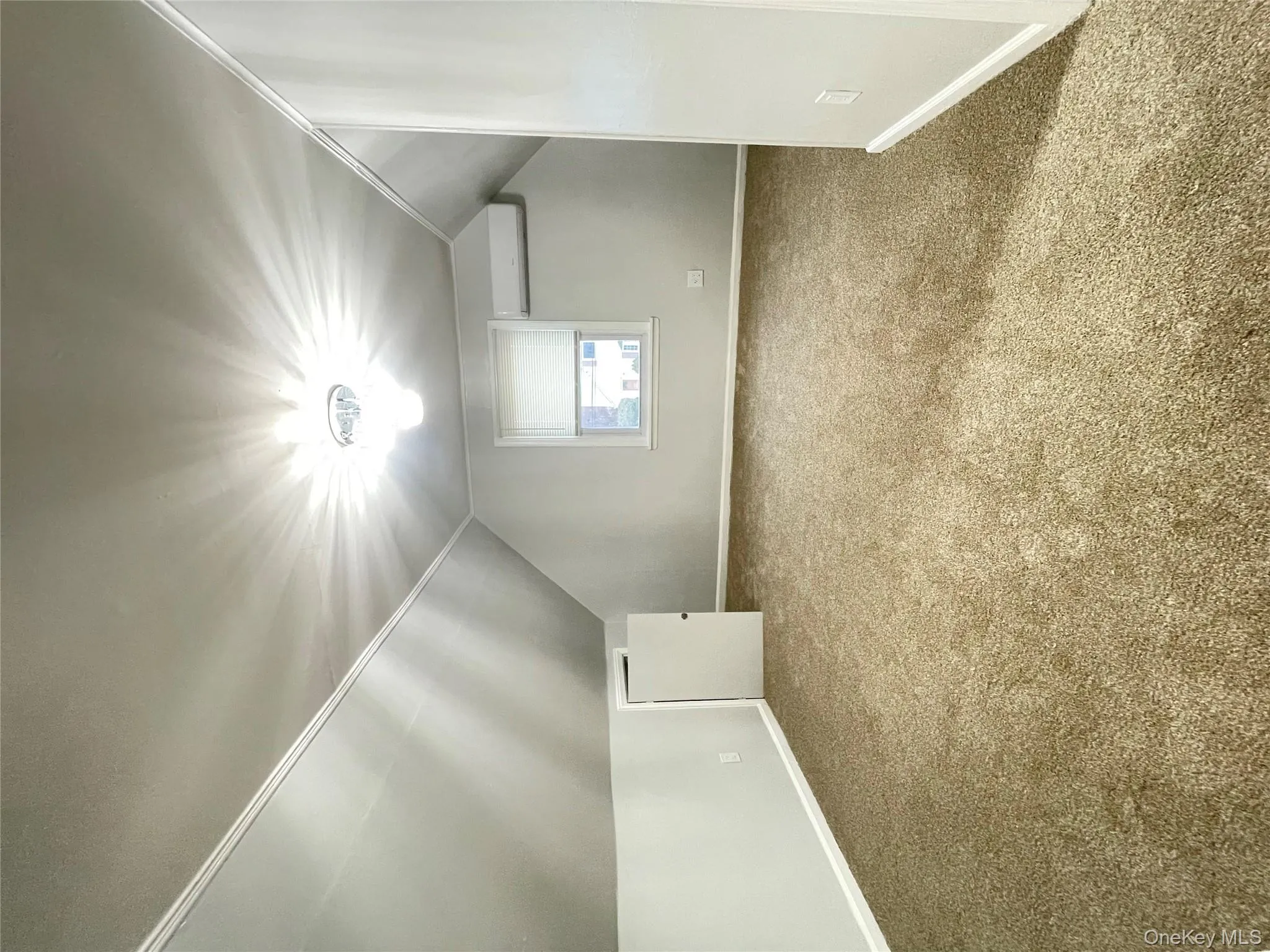 Bonus room with vaulted ceiling, carpet, and a wall mounted air conditioner Bonus room with vaulted ceiling, carpet, and a wall mounted air conditioner