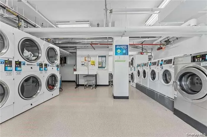 Community laundry room with independent washer and dryer and stacked washer and clothes dryer Community laundry room with independent washer and dryer and stacked washer and clothes dryer