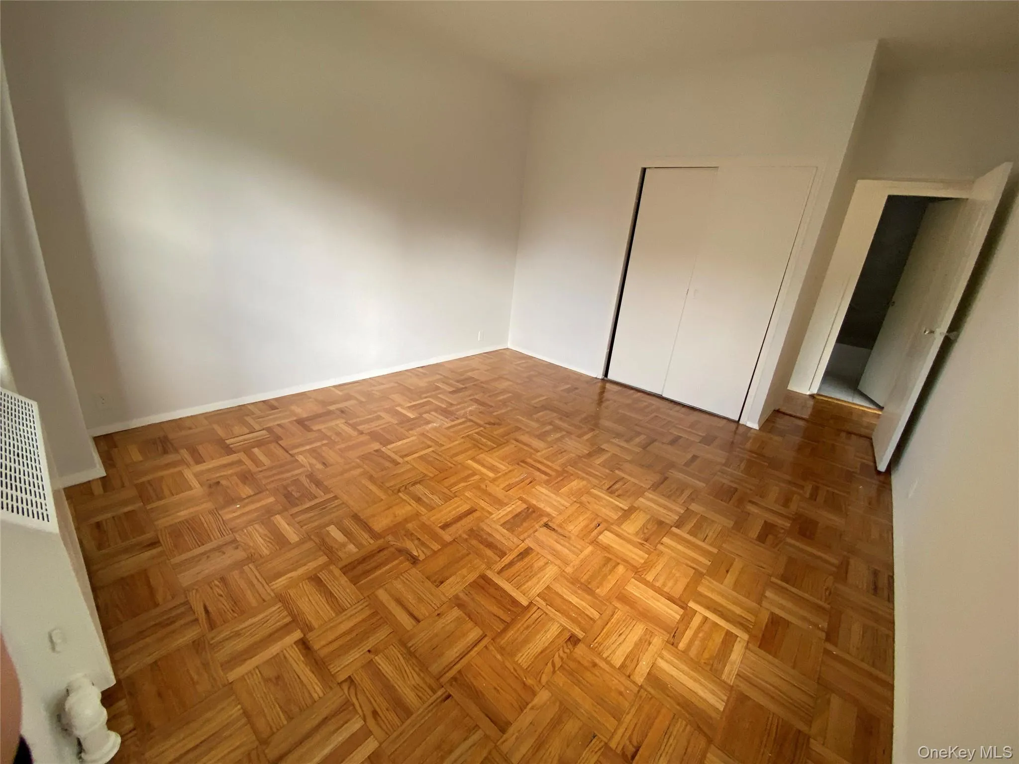 Unfurnished bedroom with a closet and a heating unit Unfurnished bedroom with a closet and a heating unit