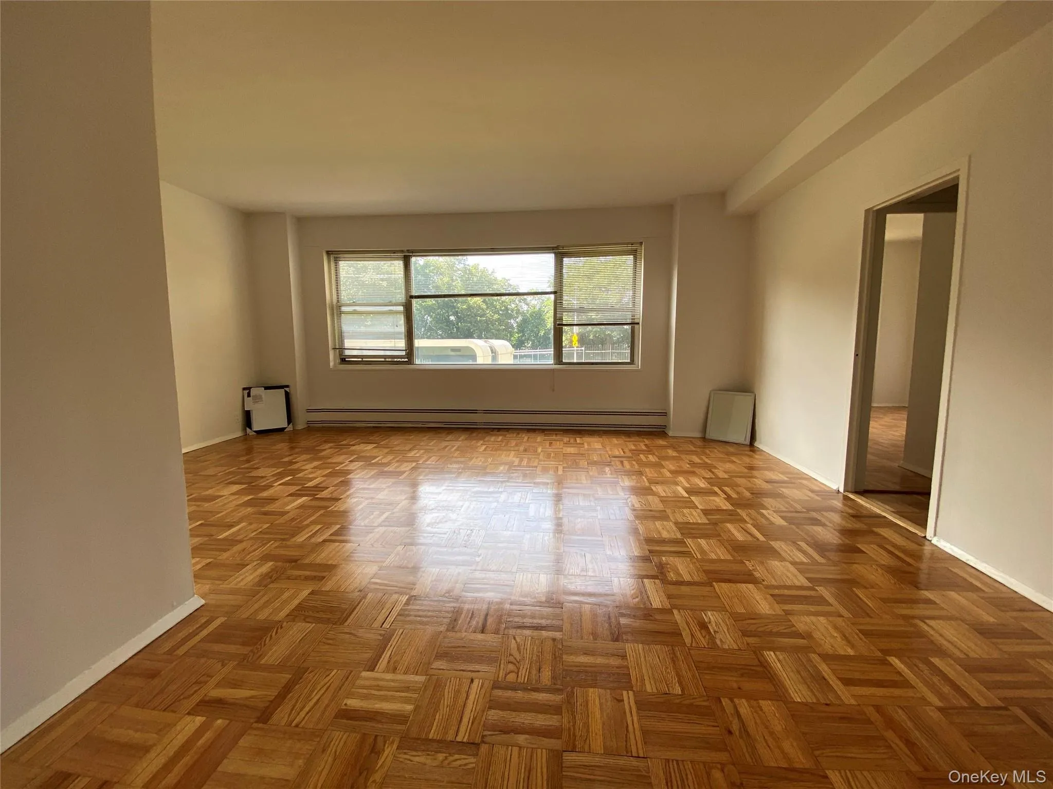 Empty room with baseboard heating and baseboards Empty room with baseboard heating and baseboards