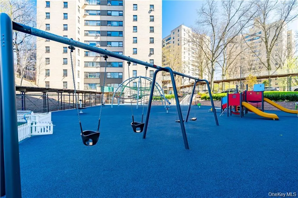 Community playground featuring a city view Community playground featuring a city view