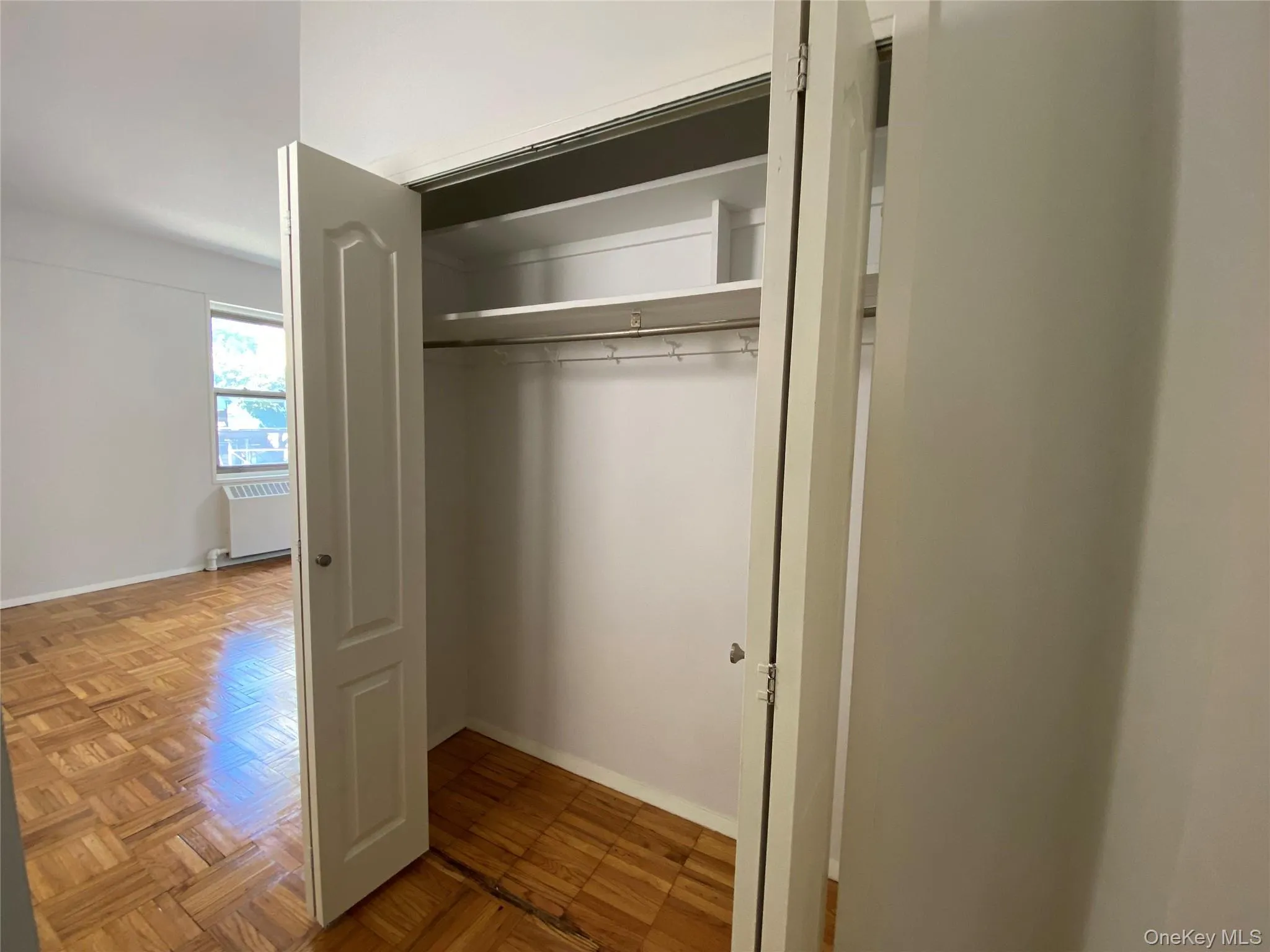Closet featuring radiator heating unit Closet featuring radiator heating unit