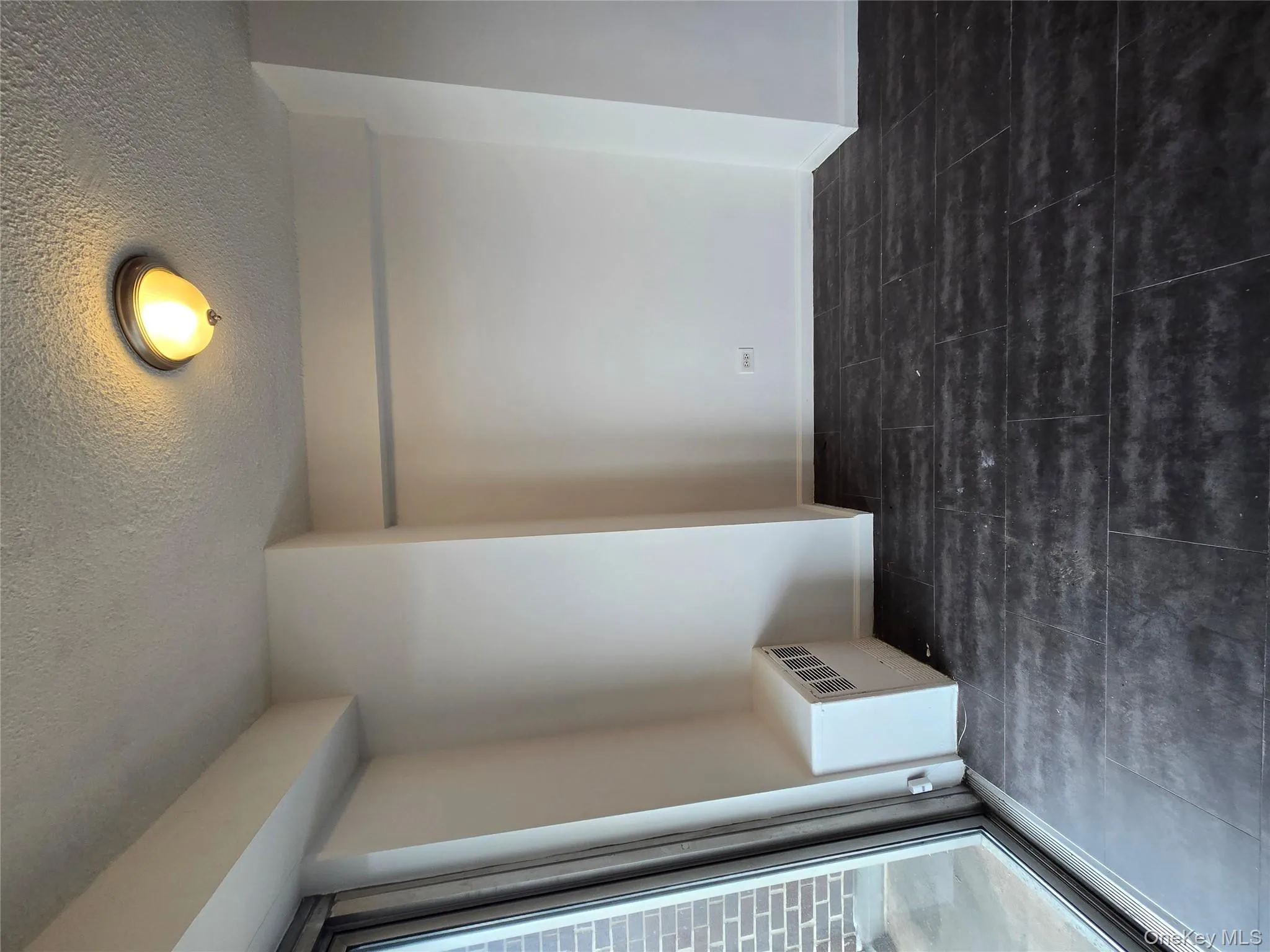 Unfurnished room featuring radiator and a textured ceiling Unfurnished room featuring radiator and a textured ceiling