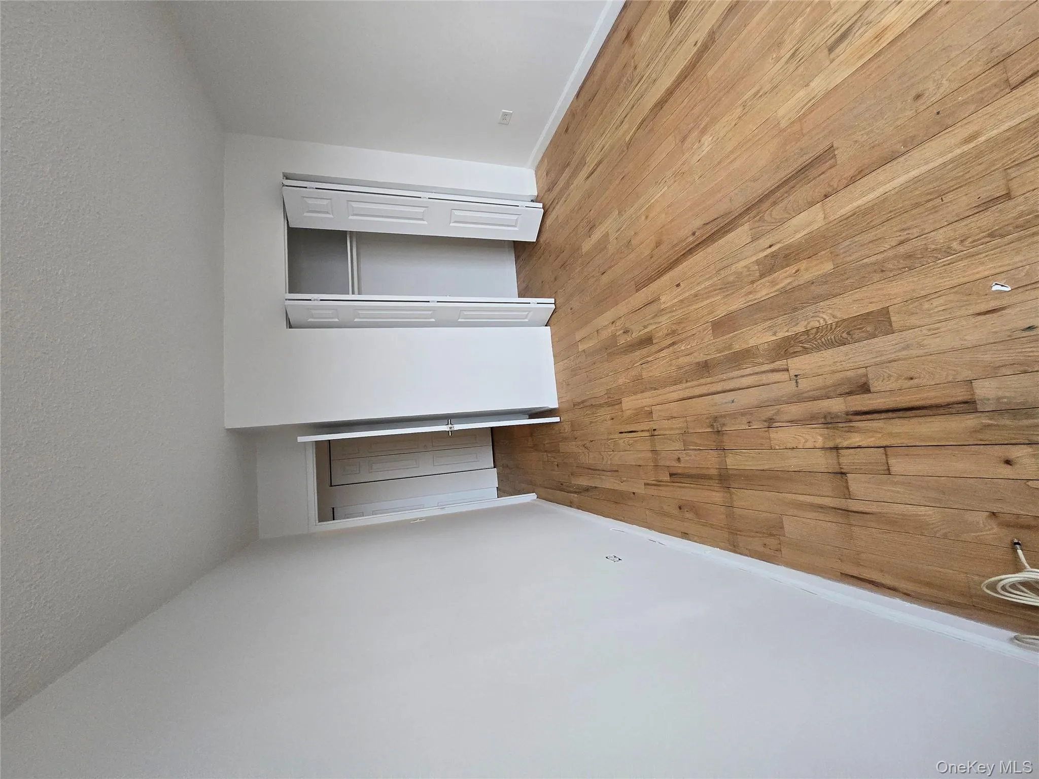 Unfurnished bedroom with light wood-style floors, a closet, and a textured ceiling Unfurnished bedroom with light wood-style floors, a closet, and a textured ceiling