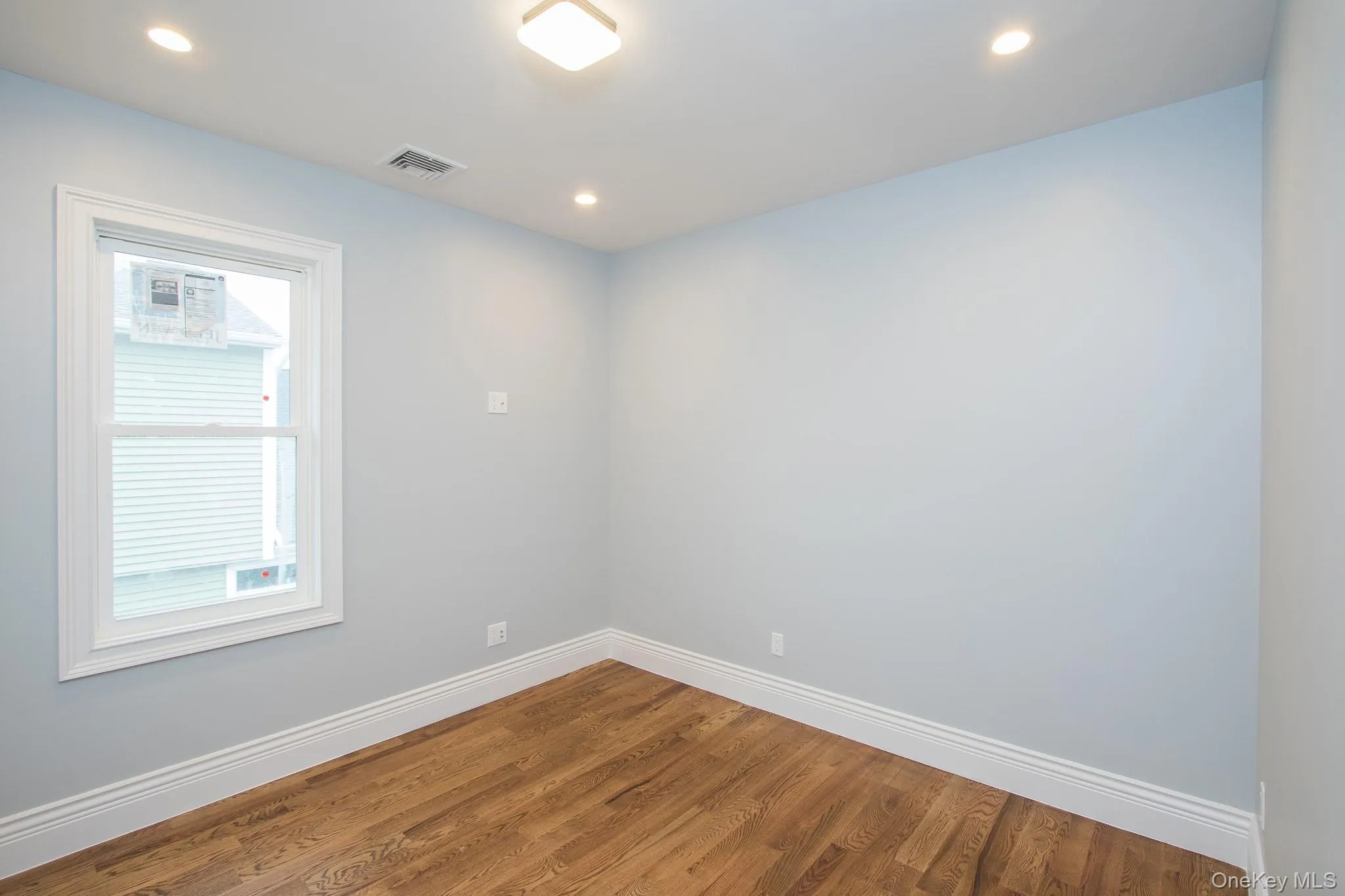 Spare room featuring wood finished floors and recessed lighting Spare room featuring wood finished floors and recessed lighting