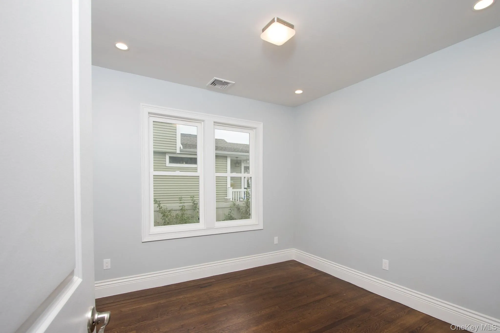 Unfurnished room featuring dark wood-style flooring and recessed lighting Unfurnished room featuring dark wood-style flooring and recessed lighting