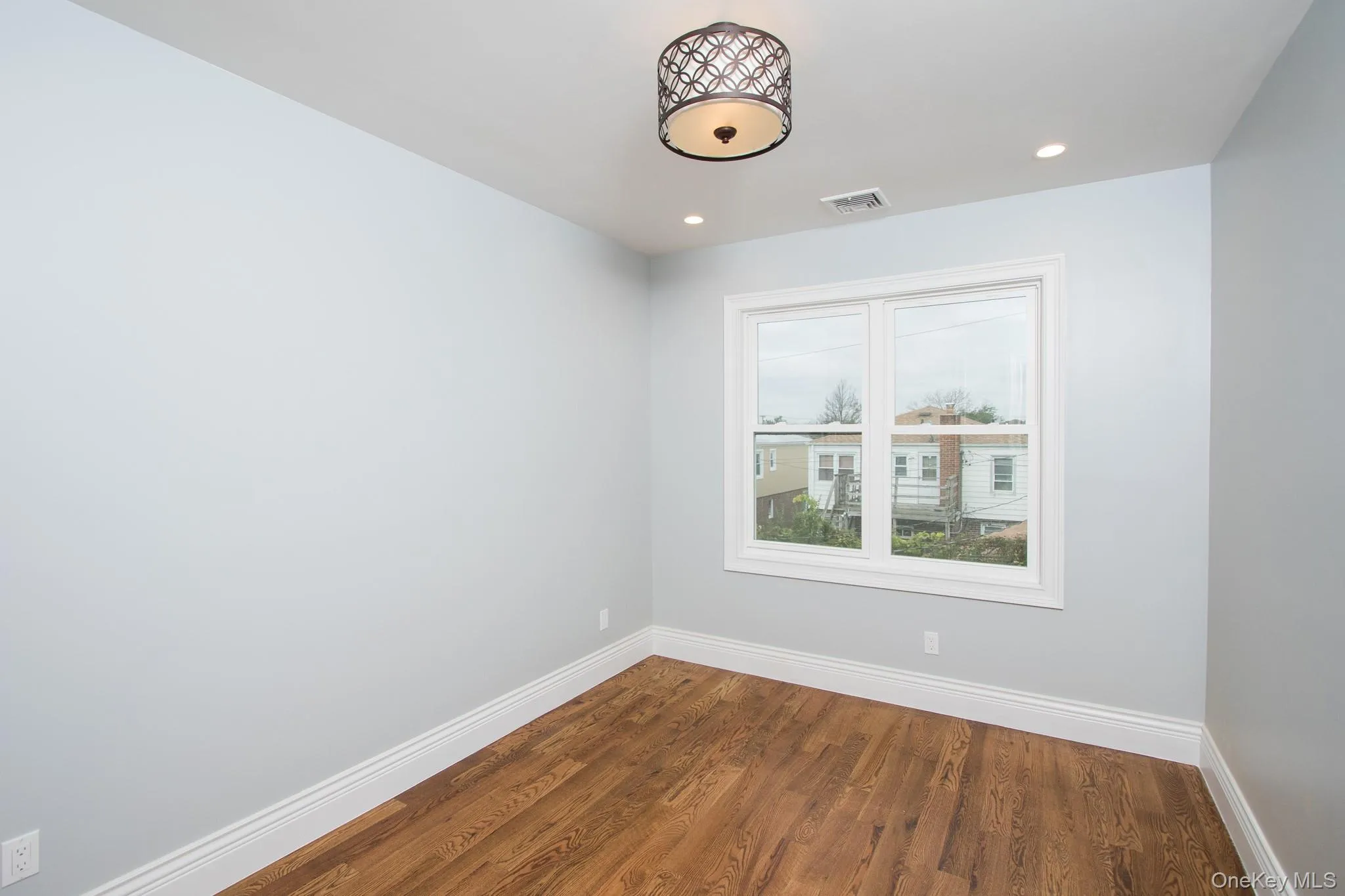 Spare room featuring wood finished floors and recessed lighting Spare room featuring wood finished floors and recessed lighting