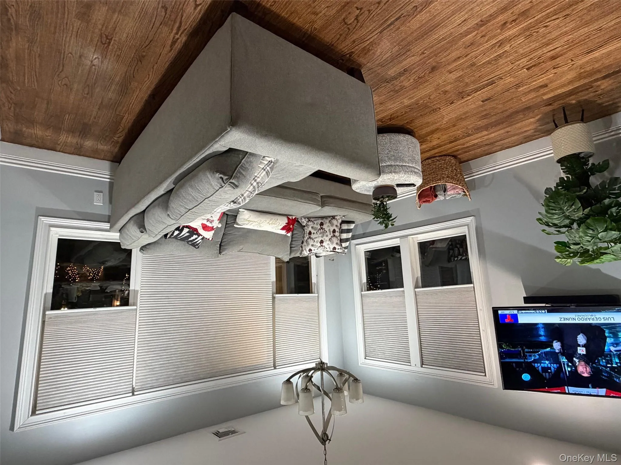 Living area with dark wood-style floors and a chandelier Living area with dark wood-style floors and a chandelier