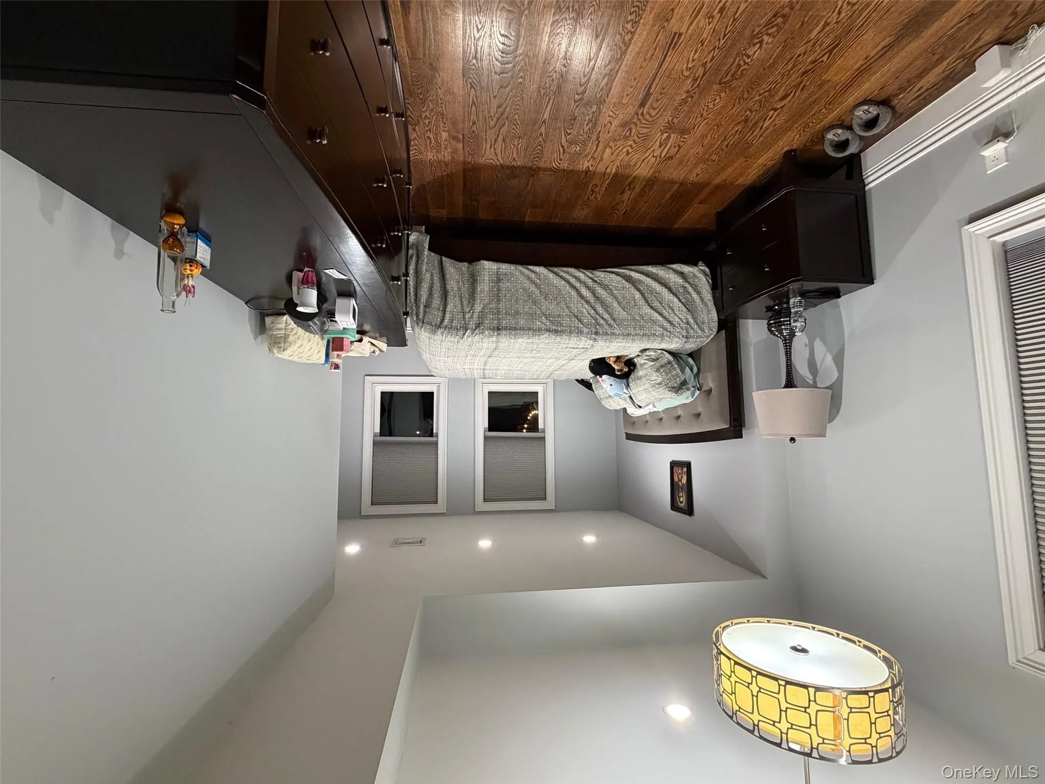 Bedroom with dark wood-type flooring and recessed lighting Bedroom with dark wood-type flooring and recessed lighting