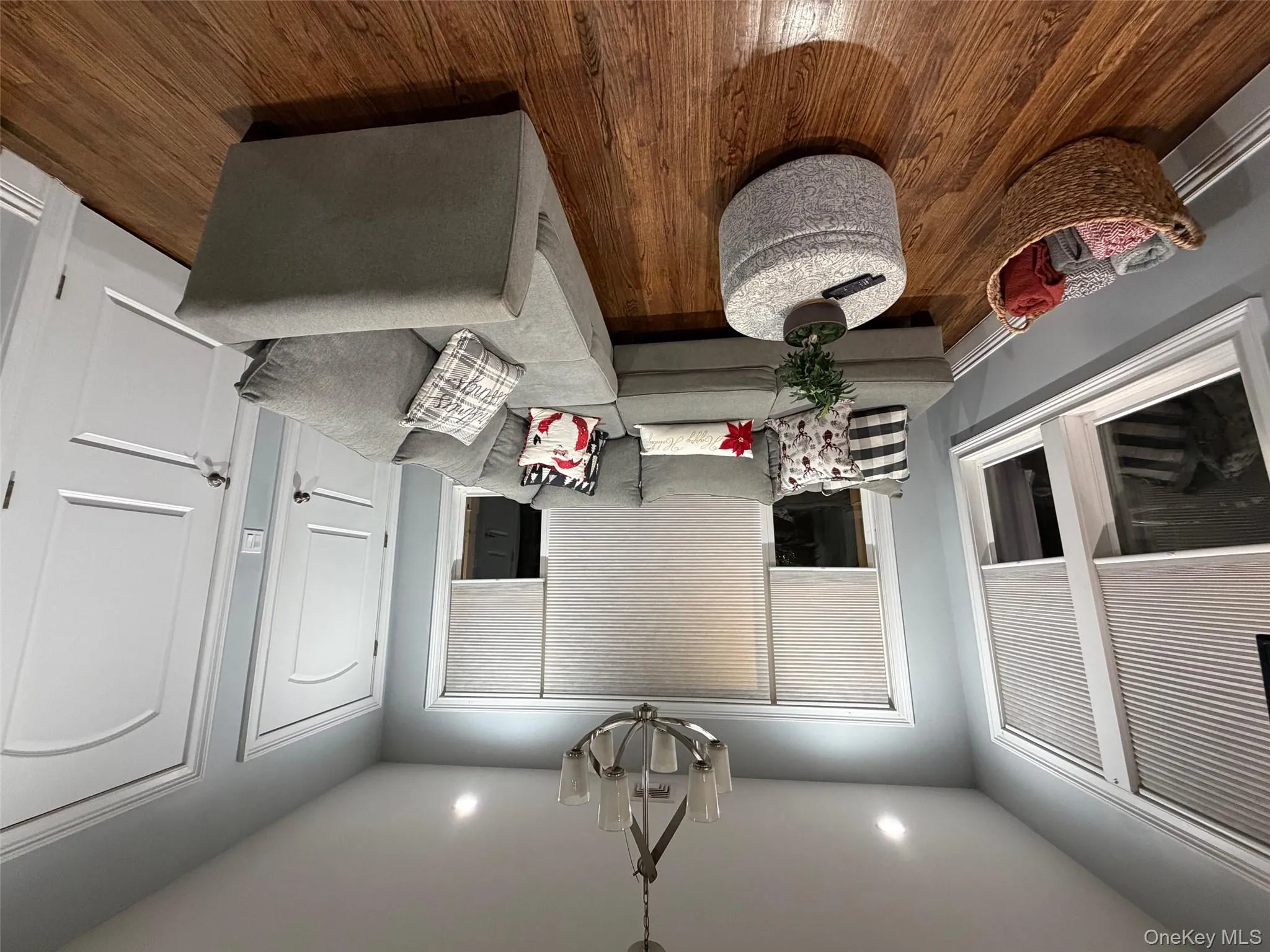 Living area featuring dark wood-style flooring, a chandelier, recessed lighting, and baseboard heating Living area featuring dark wood-style flooring, a chandelier, recessed lighting, and baseboard heating