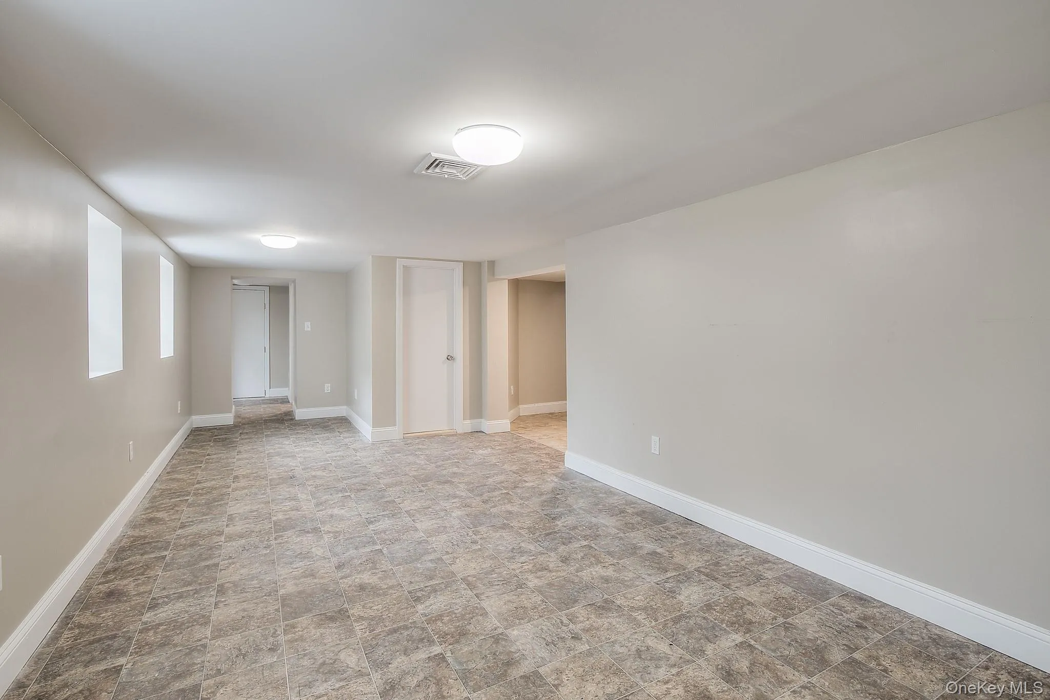 Spare room with baseboards and stone finish flooring Spare room with baseboards and stone finish flooring