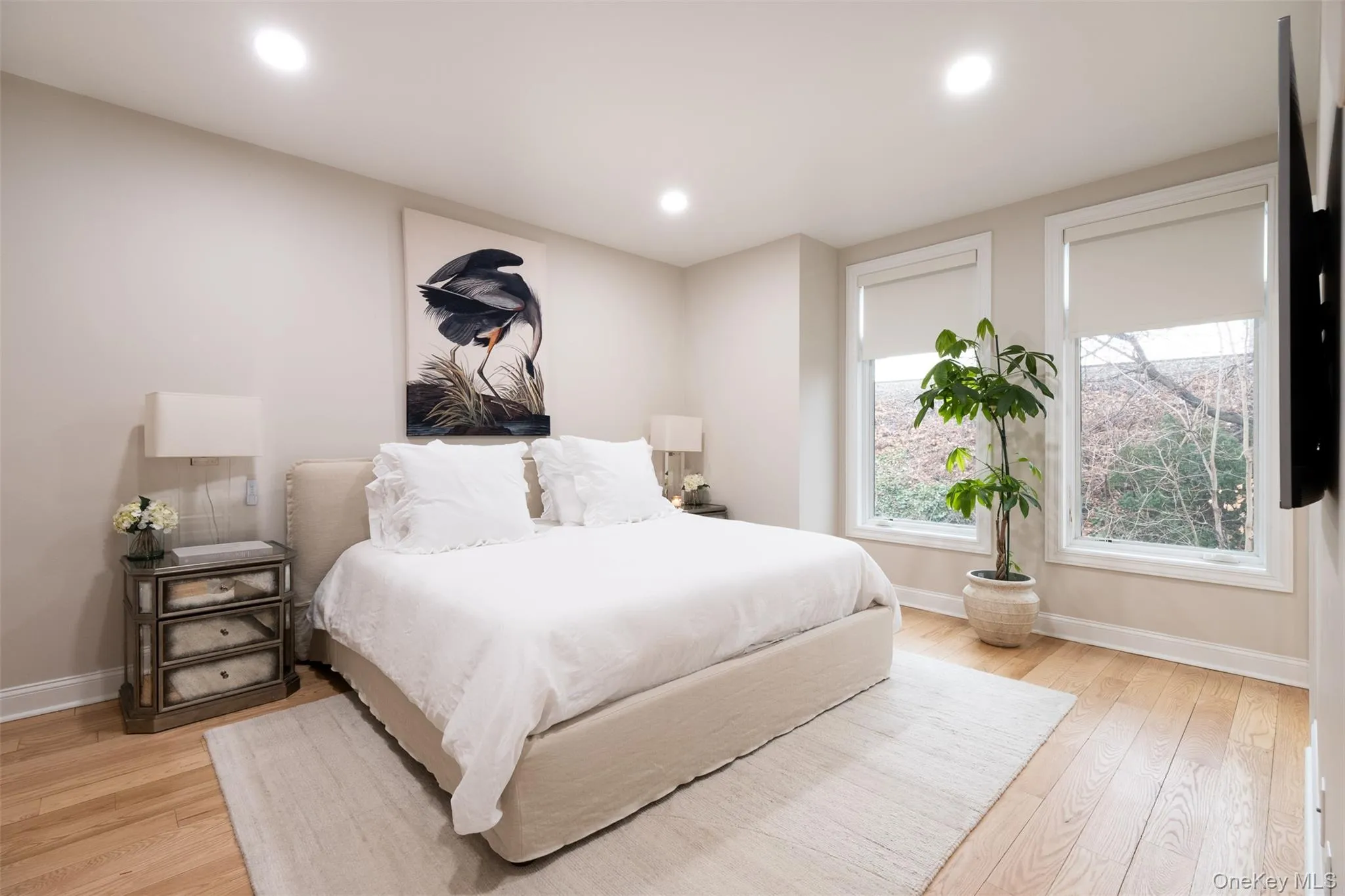 Bedroom with light wood finished floors and recessed lighting Bedroom with light wood finished floors and recessed lighting