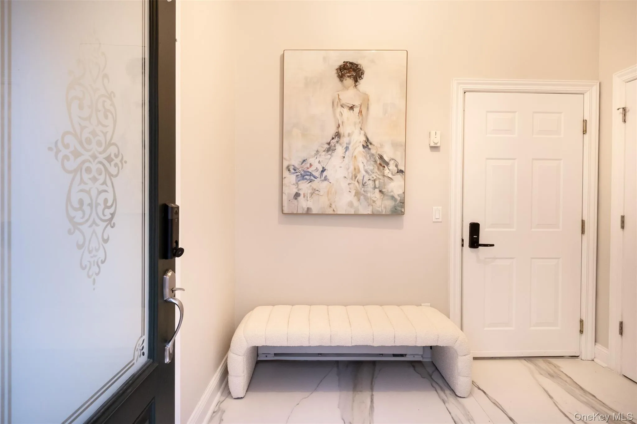 Entryway with marble finish floors and baseboards Entryway with marble finish floors and baseboards