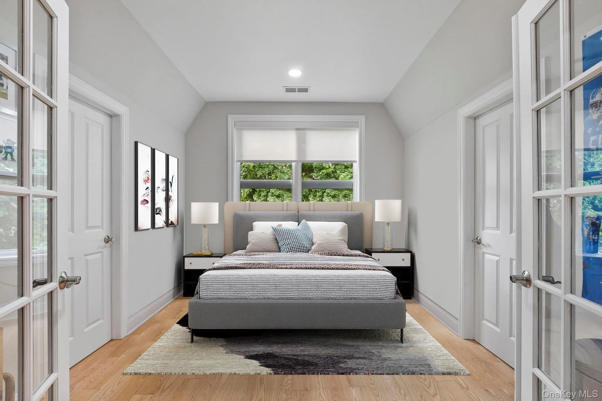 Virtually Staged Bedroom featuring vaulted ceiling and light wood-style floors Virtually Staged Bedroom featuring vaulted ceiling and light wood-style floors