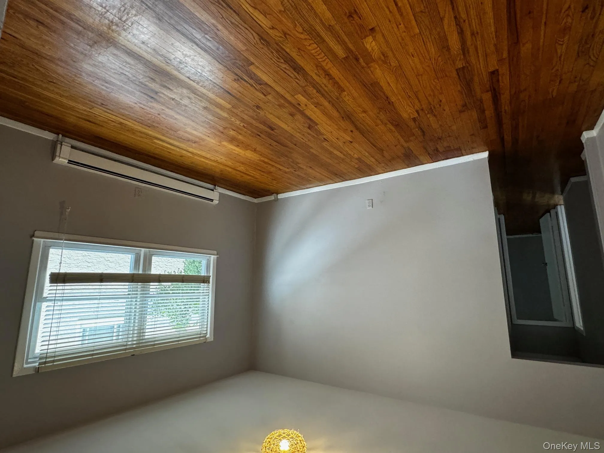 Spare room with a baseboard heating unit and hardwood / wood-style floors Spare room with a baseboard heating unit and hardwood / wood-style floors