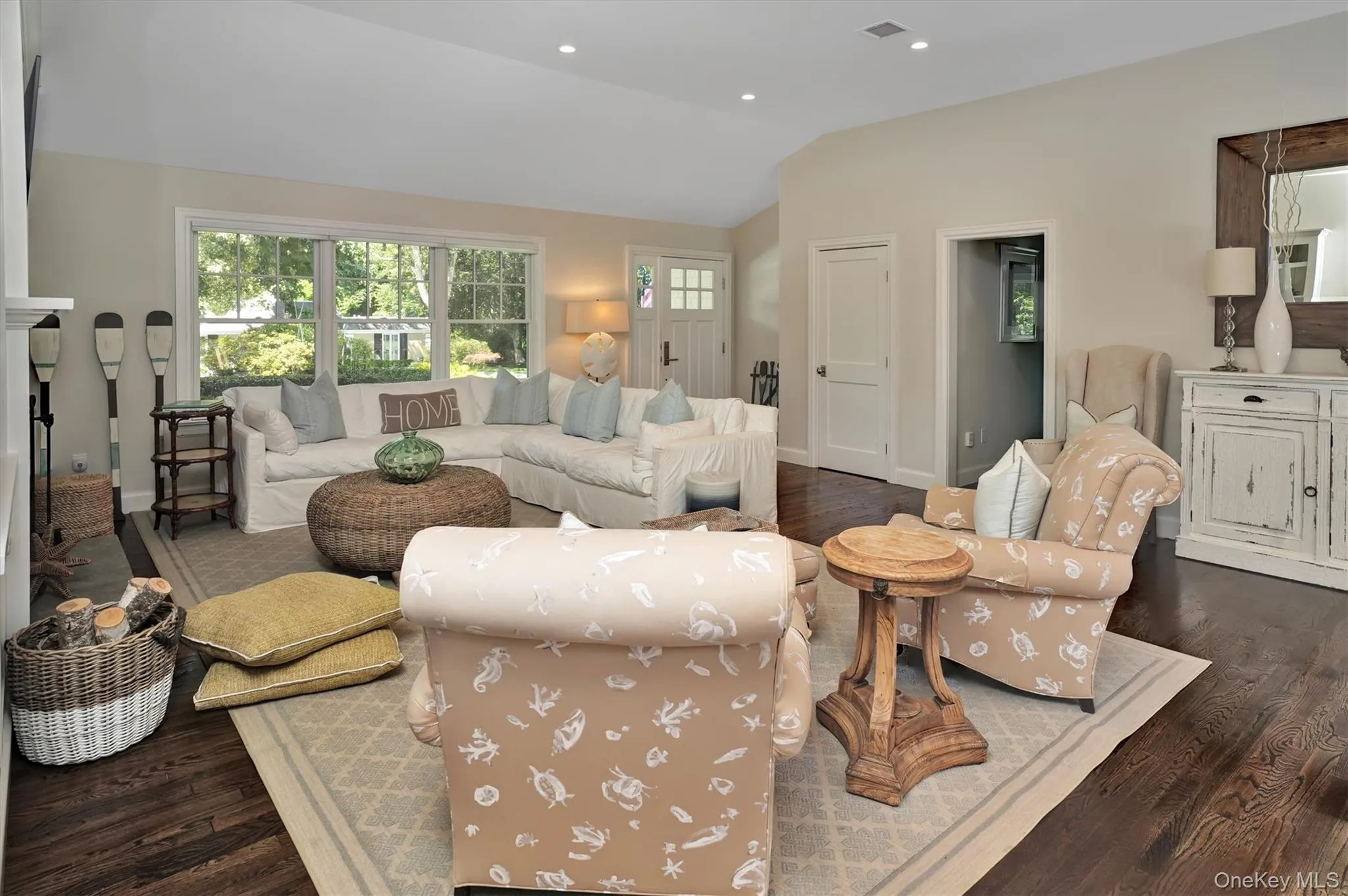 Living room with dark wood finished floors, vaulted ceiling, and recessed lighting Living room with dark wood finished floors, vaulted ceiling, and recessed lighting