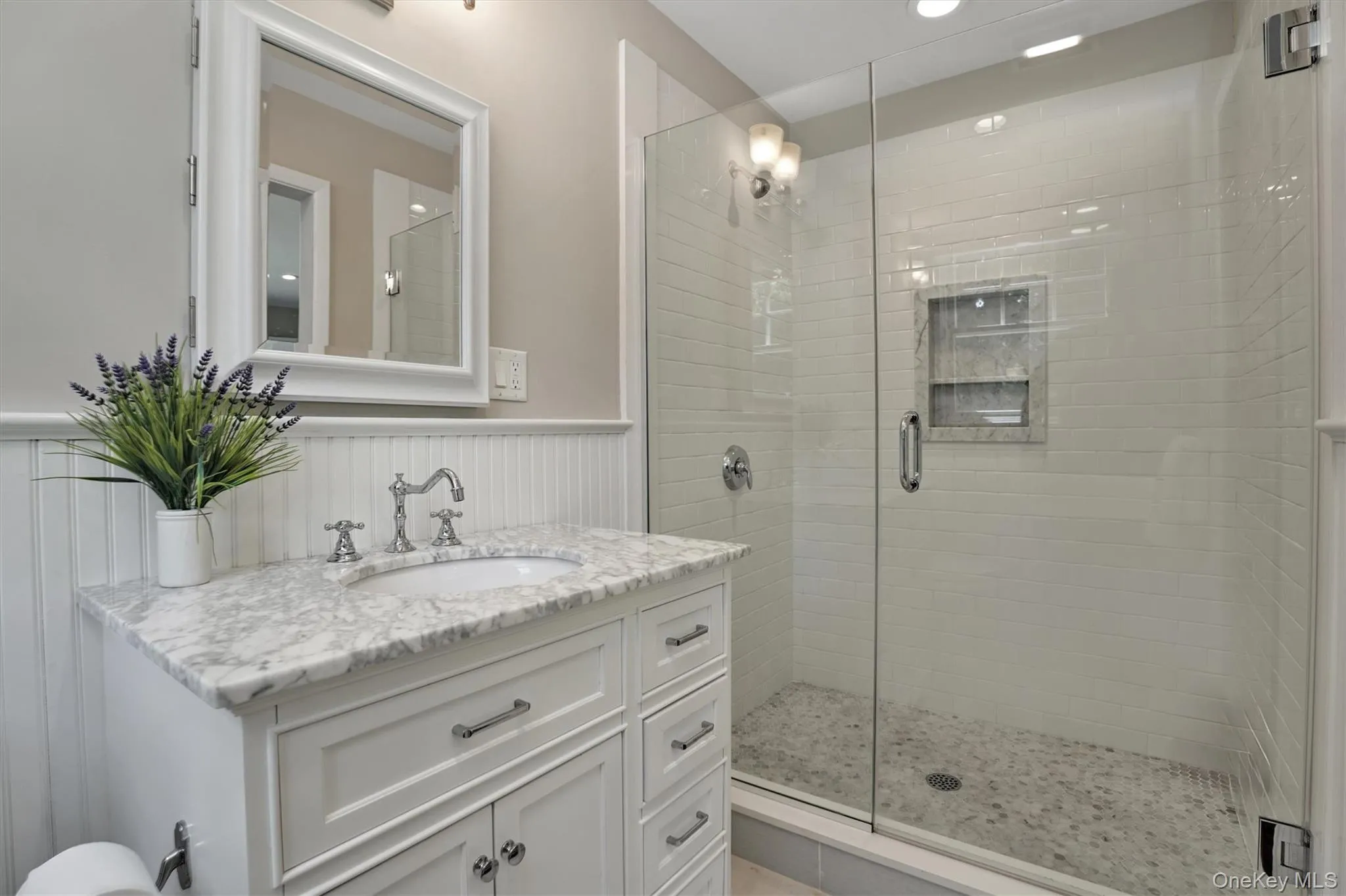 Bathroom featuring a shower stall, wainscoting, vanity, and recessed lighting Bathroom featuring a shower stall, wainscoting, vanity, and recessed lighting