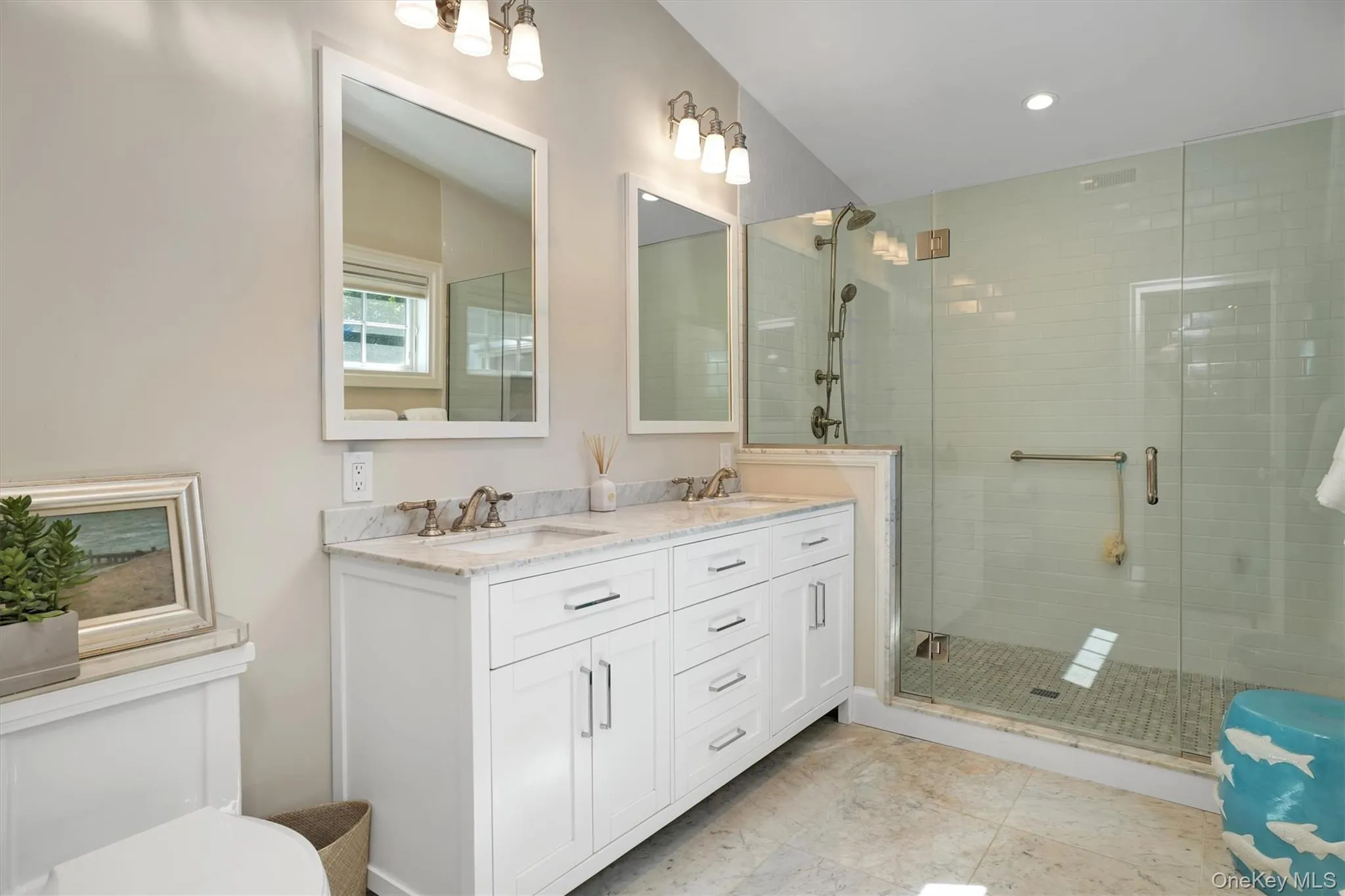 Full bath featuring double vanity and a stall shower Full bath featuring double vanity and a stall shower