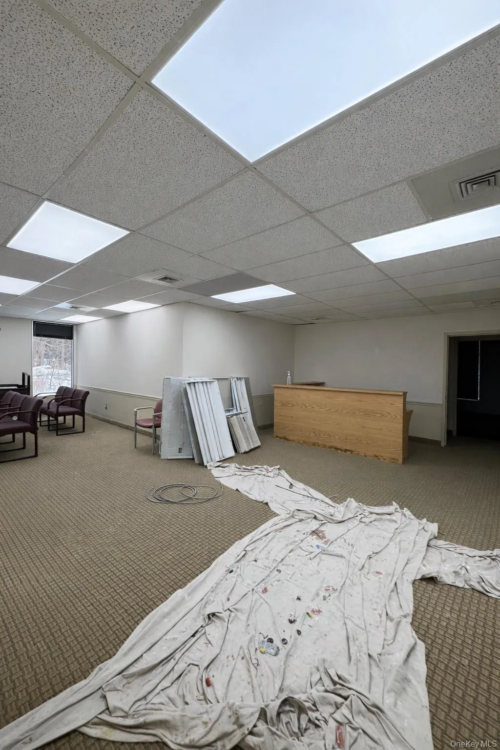 Carpeted bedroom with a paneled ceiling Carpeted bedroom with a paneled ceiling