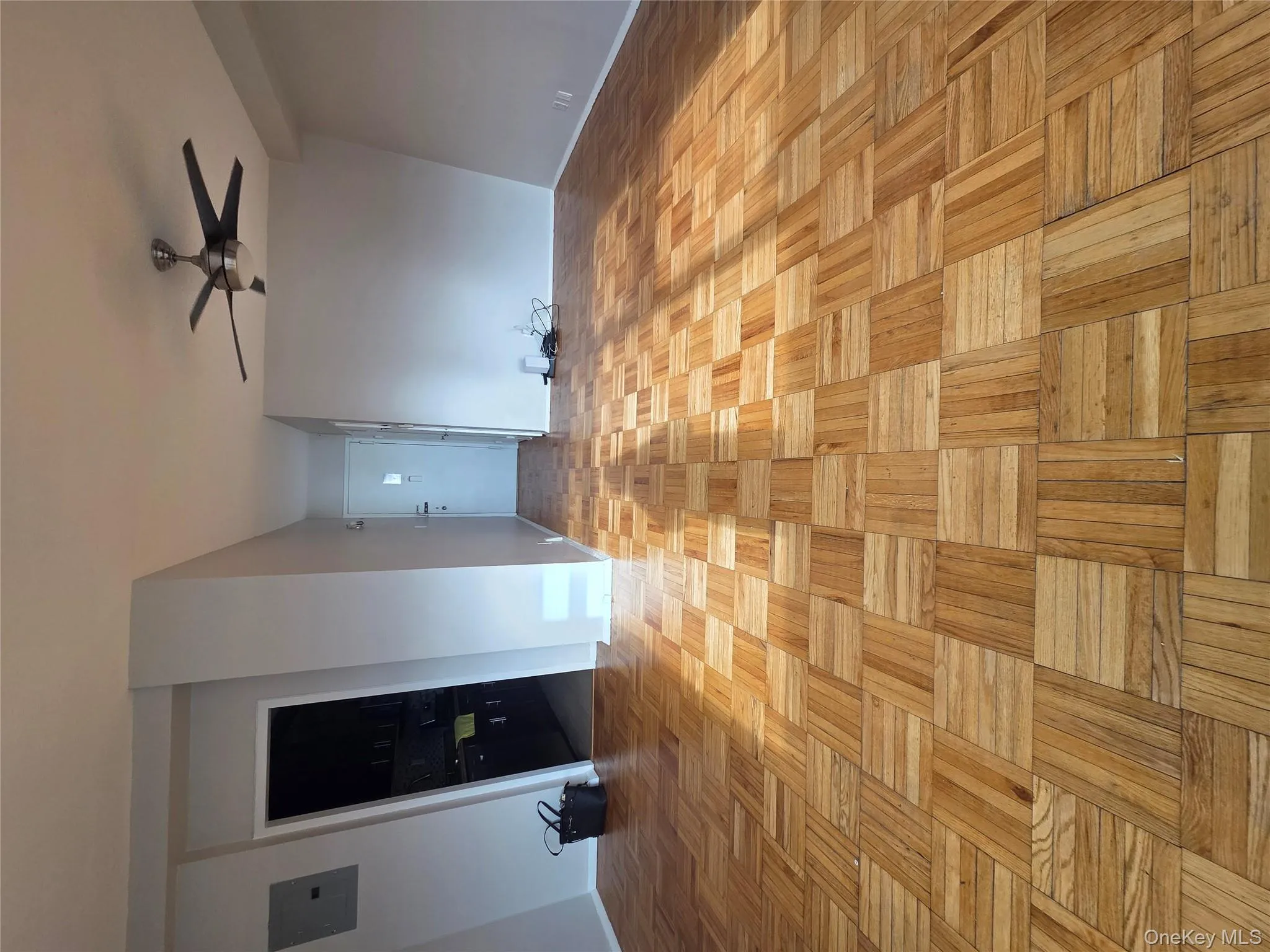 Spare room with electric panel and a ceiling fan Spare room with electric panel and a ceiling fan
