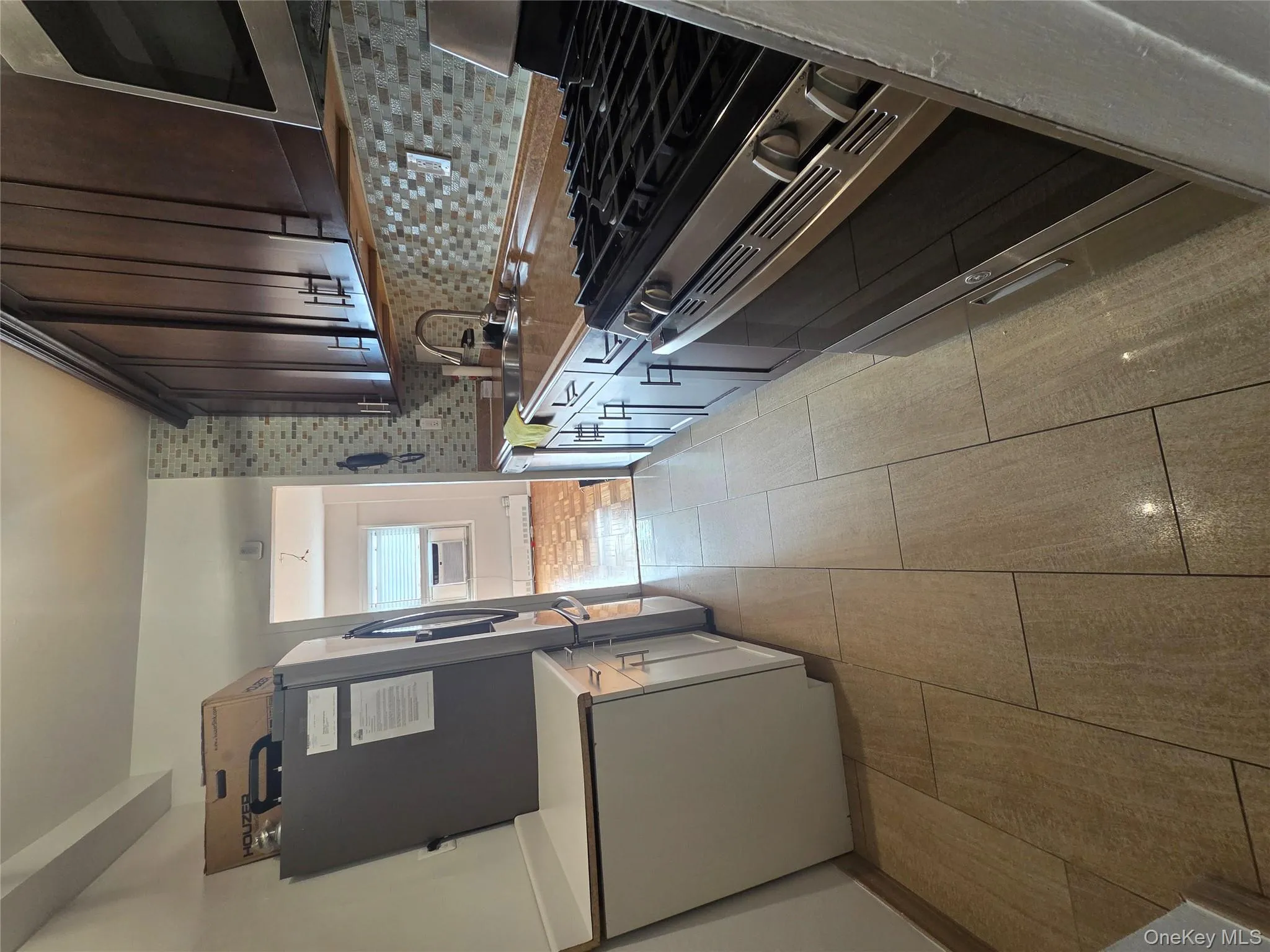 Kitchen with stainless steel appliances, tasteful backsplash, and dark brown cabinetry Kitchen with stainless steel appliances, tasteful backsplash, and dark brown cabinetry