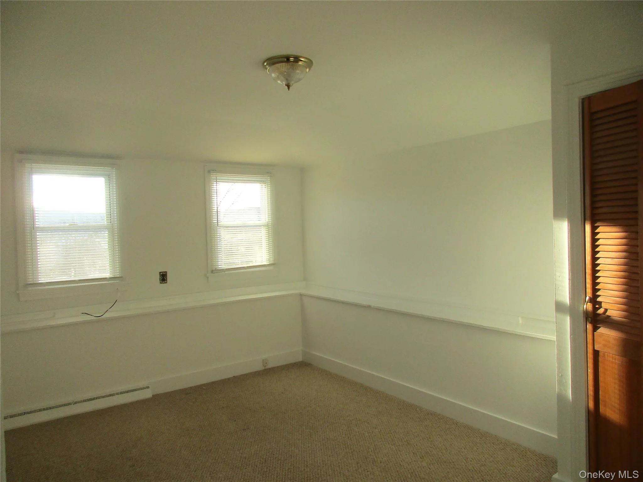 Carpeted bedroom with shelving. Carpeted bedroom with shelving.