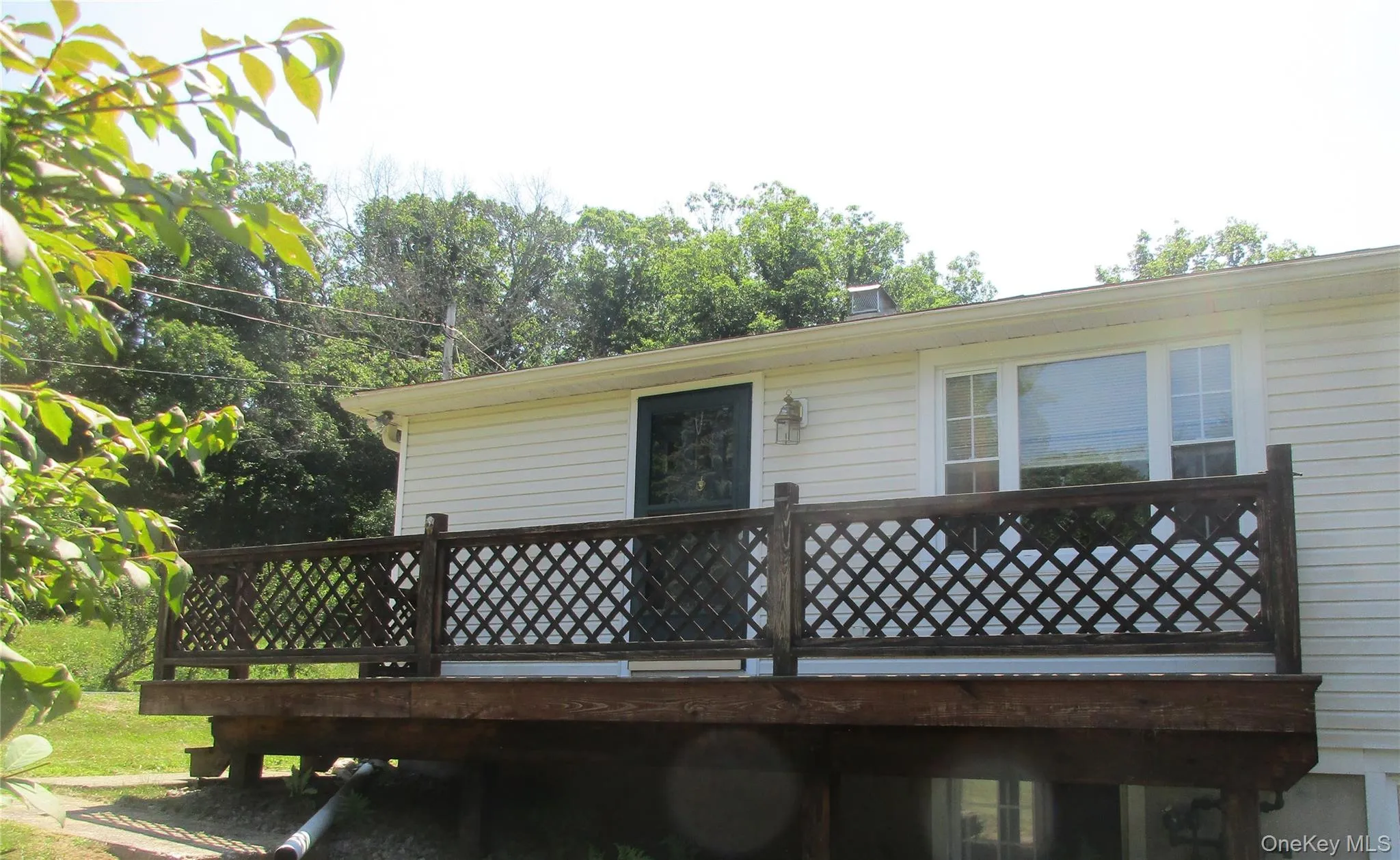 Deck side picture windows living room.Beautiful view of lawns. Deck side picture windows living room.Beautiful view of lawns.
