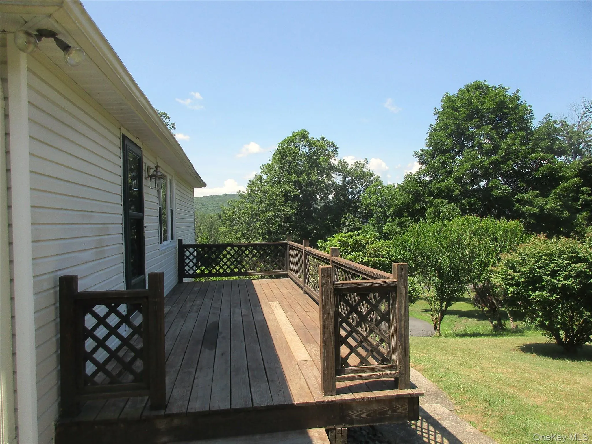 Entrance steps to deck also a door from living rm deck overlooks pretty yard Entrance steps to deck also a door from living rm deck overlooks pretty yard