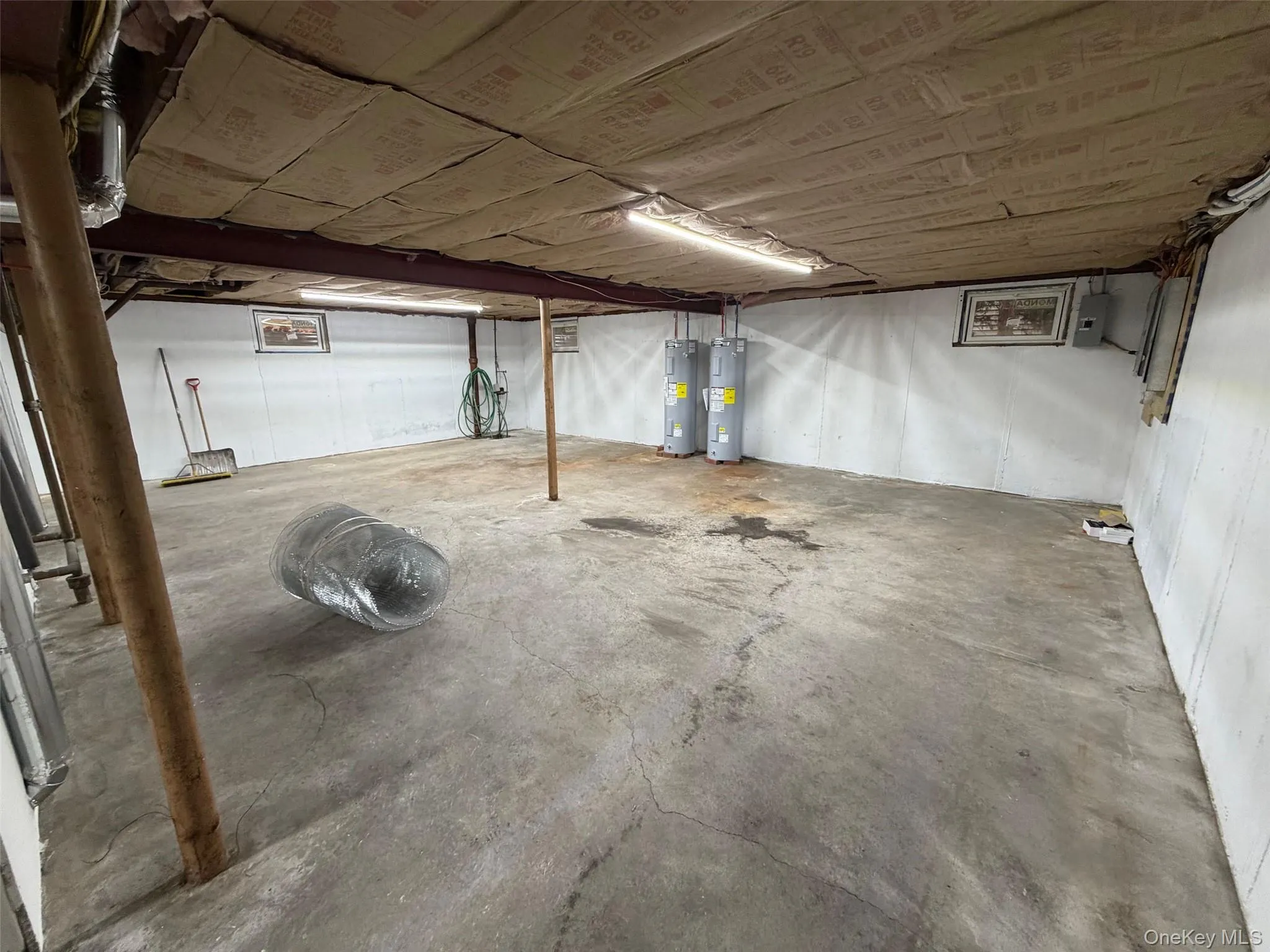 Unfinished basement with water heater Unfinished basement with water heater