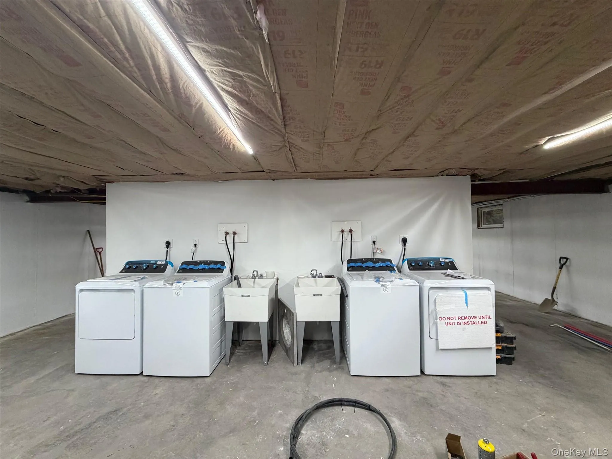 Laundry area with washer and dryer and concrete floors Laundry area with washer and dryer and concrete floors
