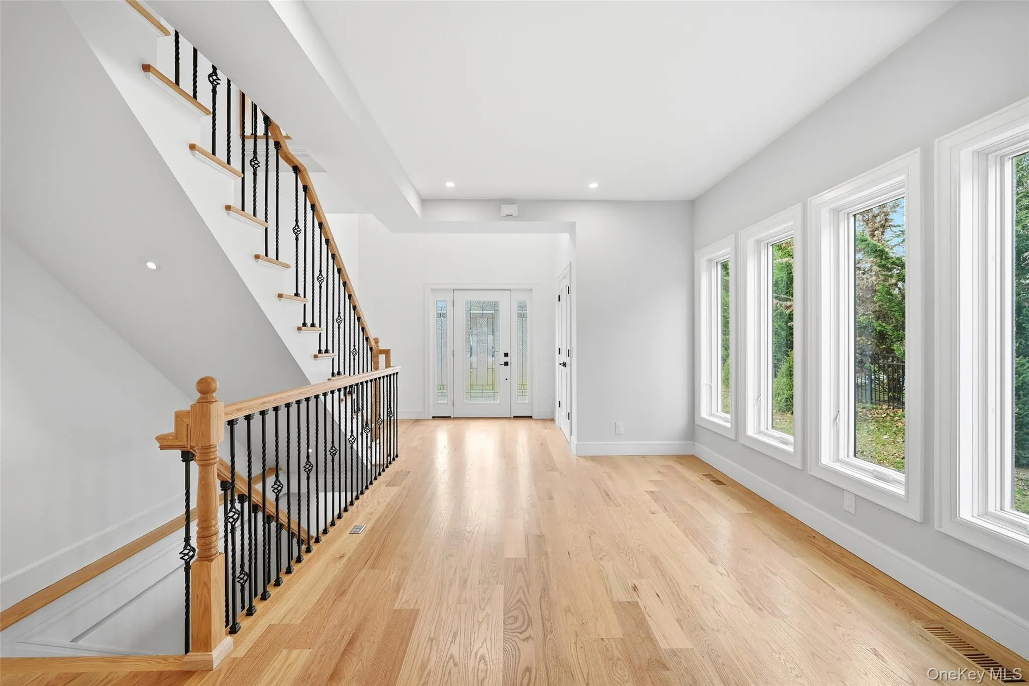 Entrance foyer with light wood-style flooring, recessed lighting, and stairs Entrance foyer with light wood-style flooring, recessed lighting, and stairs