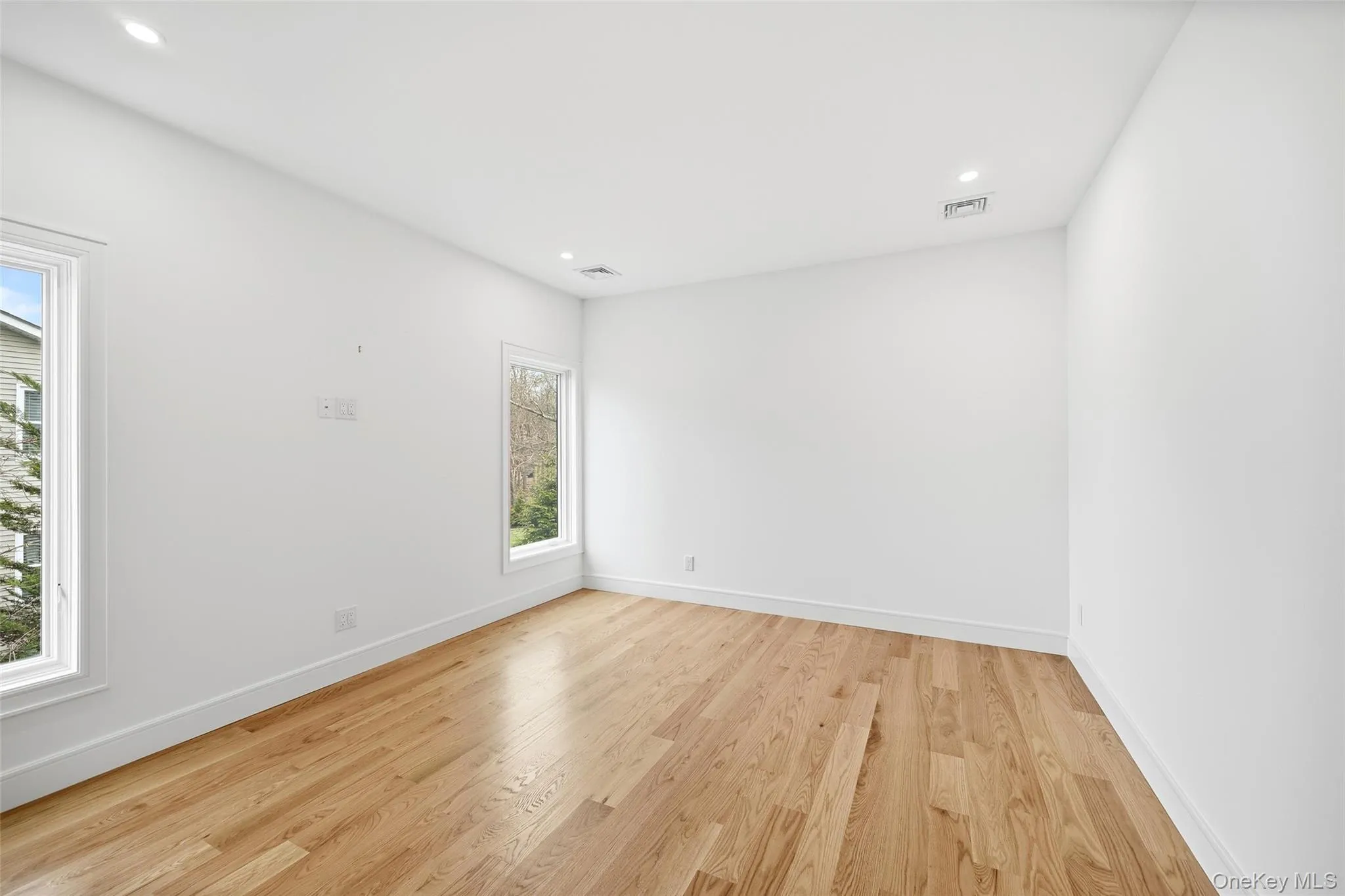 Unfurnished room featuring light wood-style flooring and recessed lighting Unfurnished room featuring light wood-style flooring and recessed lighting