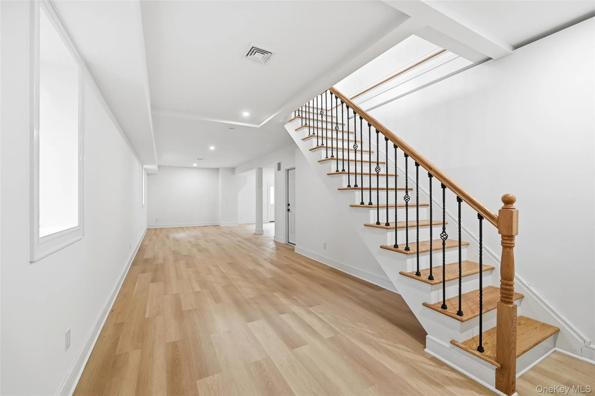 Stairway with wood finished floors and recessed lighting Stairway with wood finished floors and recessed lighting