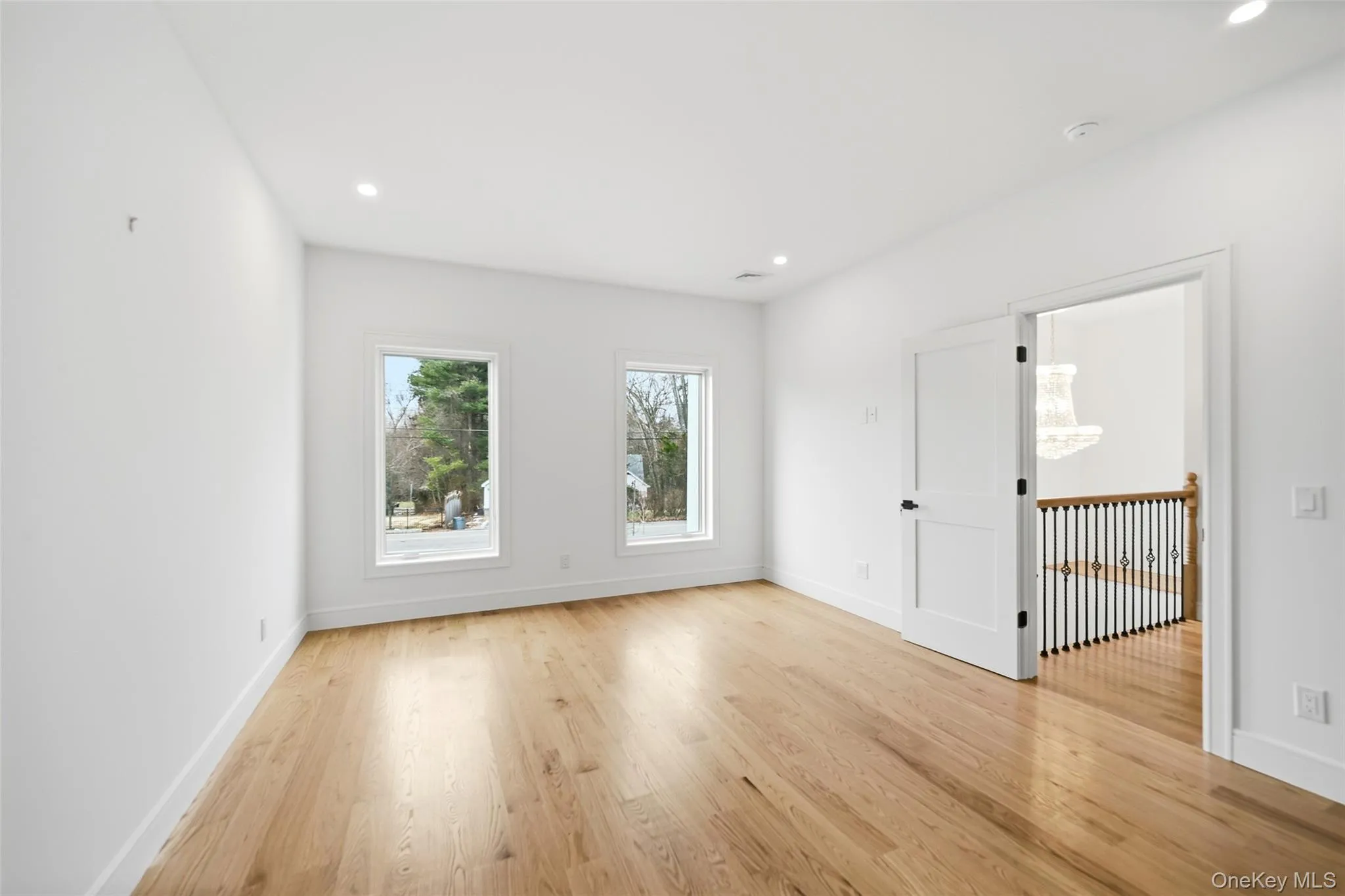 Spare room with light wood-type flooring and recessed lighting Spare room with light wood-type flooring and recessed lighting