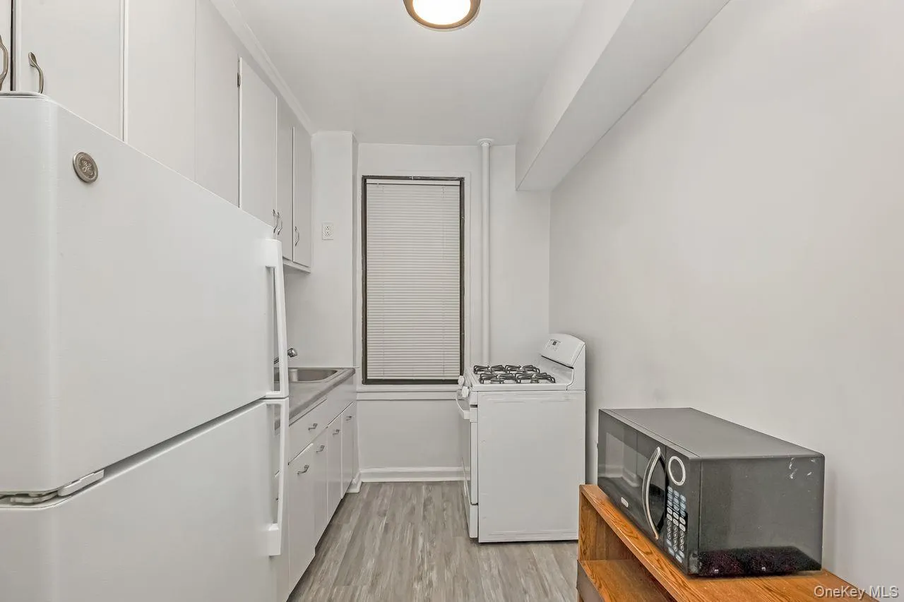 Washroom featuring light wood finished floors and a sink Washroom featuring light wood finished floors and a sink