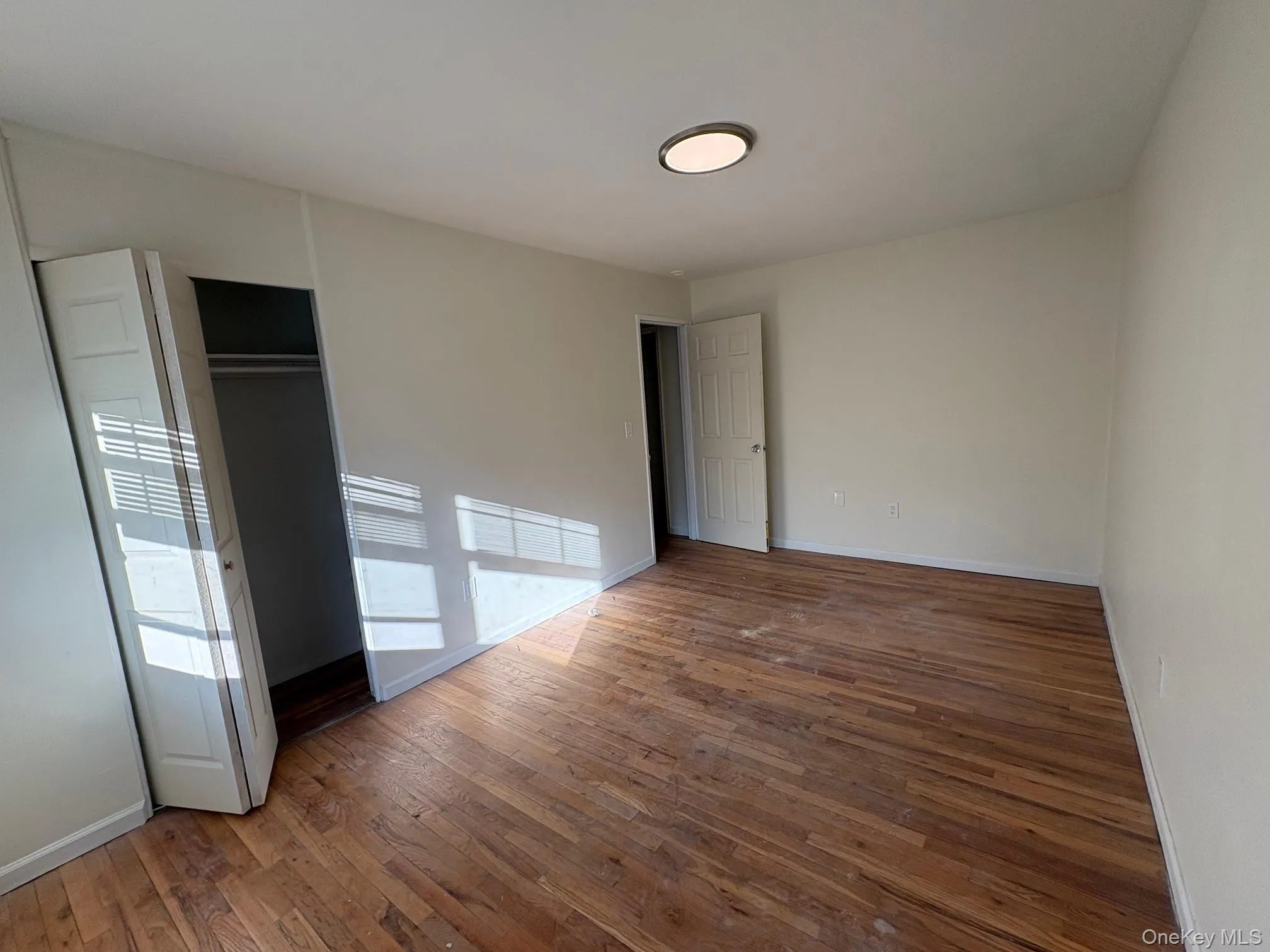 Bedroom 2 featuring hardwood flooring and closet Bedroom 2 featuring hardwood flooring and closet